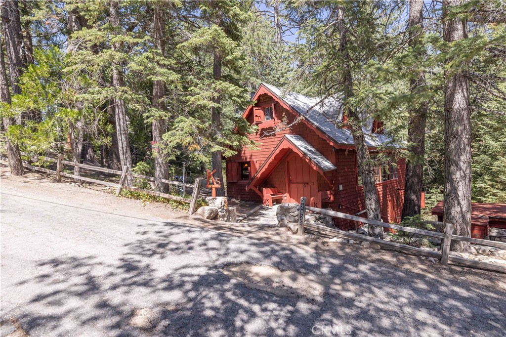 Welcome to this cozy mountain retreat, proudly offered for the first time since it was built! Nestled in the heart of Arrowbear, this 3-bedroom, 1-bathroom cabin offers 1,020 square feet of warm, inviting living space and sits on an expansive corner lot of over 12,000 square feet.
Step inside to a bright and airy living room featuring a stunning 16-foot window that floods the space with natural light and frames the peaceful forest views. A classic rock fireplace anchors the room and adds rustic charm—perfect for those crisp mountain evenings.
The large primary bedroom is located on the lower floor with private access to the yard providing both comfort and convenience. Two additional upstairs bedrooms offer flexible space for guests, family, or a home office.
Outside, the spacious yard is equipped with a sprinkler system and surrounded by mature trees, offering privacy and plenty of room to relax or entertain. Off-street parking and the desirable corner lot location complete this rare offering.
Don’t miss your chance to own a piece of Arrowbear history—this home has never been on the market and is ready for its next chapter.