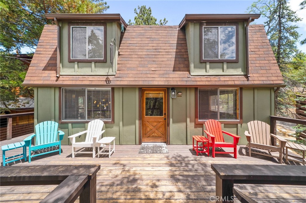 Nestled among the towering pines and tranquil mountain landscape of Idyllwild, this beautifully maintained and thoughtfully upgraded cabin offers the perfect blend of rustic charm and modern comfort. Surrounded by nature, the home features a spacious wrap-around deck—ideal for relaxing, entertaining, or soaking in the peaceful forest views. Step inside to find warm wood paneling and natural textures that create a cozy, inviting atmosphere. The main living room offers an open-concept layout perfect for gatherings or quiet evenings by the fire. Just off the main level is a bonus secondary living room, providing flexible space for lounging, media, or multi-generational living. Connected to this bonus room is a walk-in bedroom with an en suite bathroom, functioning as a junior primary suite—ideal for guests or extended family. The remodeled eat-in kitchen features updated appliances, ample counter space, and a welcoming layout for casual meals and conversation. Upstairs, the primary suite provides a peaceful retreat, complete with its own private bathroom and serene tree-top views. With three full bathrooms in total, privacy and convenience are built in. Additional highlights include an upgraded outdoor staircase with modern wire railing, a basement space perfect for storage, an upgraded electrical panel, and blinds on every window for privacy and natural light control. Lovingly cared for throughout ownership, this home is truly move-in ready. Whether you're seeking a serene weekend escape or a full-time residence in one of California’s most beloved mountain communities, 26530 Crestview Drive delivers comfort, flexibility, and timeless mountain character.