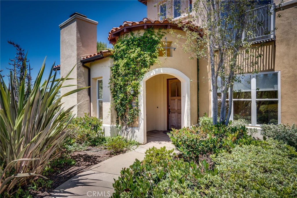 Welcome to 12 Savona Ct, a rare and refined residence nestled in the prestigious gated community of Trovare in Newport Coast. This highly desirable corner-end unit stands out with no neighbors above or below, offering a quiet, private retreat with a premium layout rarely available in the coastal rental market. Infused with Tuscan character and Mediterranean warmth, this light-filled villa features arched entryways, a graceful curved staircase, and oversized windows that invite golden sunlight into every room. From the upper level, enjoy partial ocean views—a feature that elevates both lifestyle and market value in this sought-after enclave. The primary suite is spacious and serene, complete with a generous closet and a luxurious bath with double vanity, tub, and separate shower. Outside, discover a rare gem: a private, garden patio—a true sanctuary framed by lush landscaping and vibrant florals. Enjoy exclusive access to resort-style amenities!