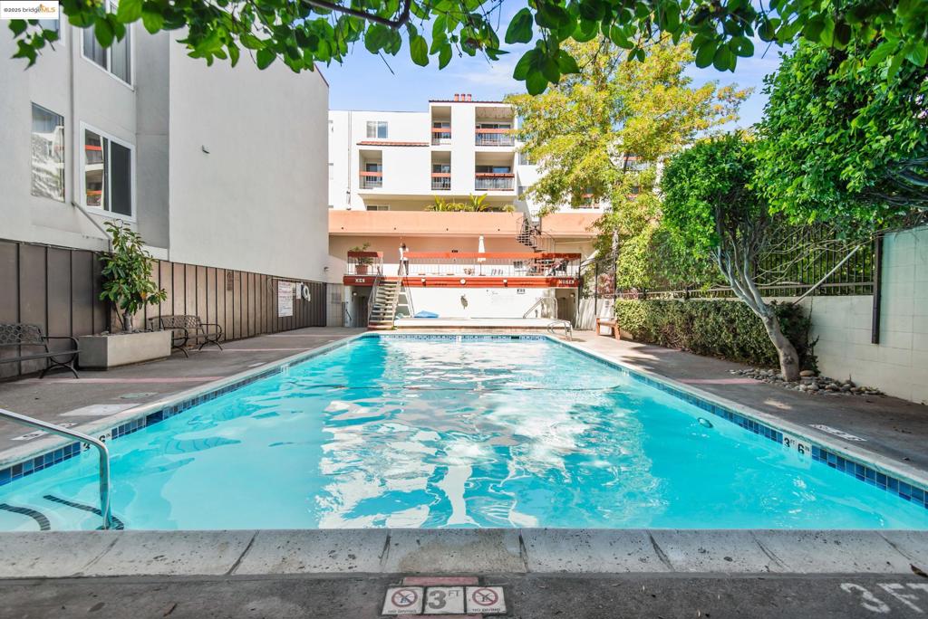 Third-floor pied-a-terre practically at a crossroads of Rockridge, Piedmont Avenue, and Temescal amenities. Updated kitchen. Fresh paint & carpet. Walk-in closet with space for a desk. Enclosed deck. The beautiful pool, spa, gym, and sauna, along with patios, make you feel like you're on vacation. Secure gated parking spot. Elevator. The third-floor location enjoys fewer shared walls. Close to transportation and MacArthur or Rockridge BART.
