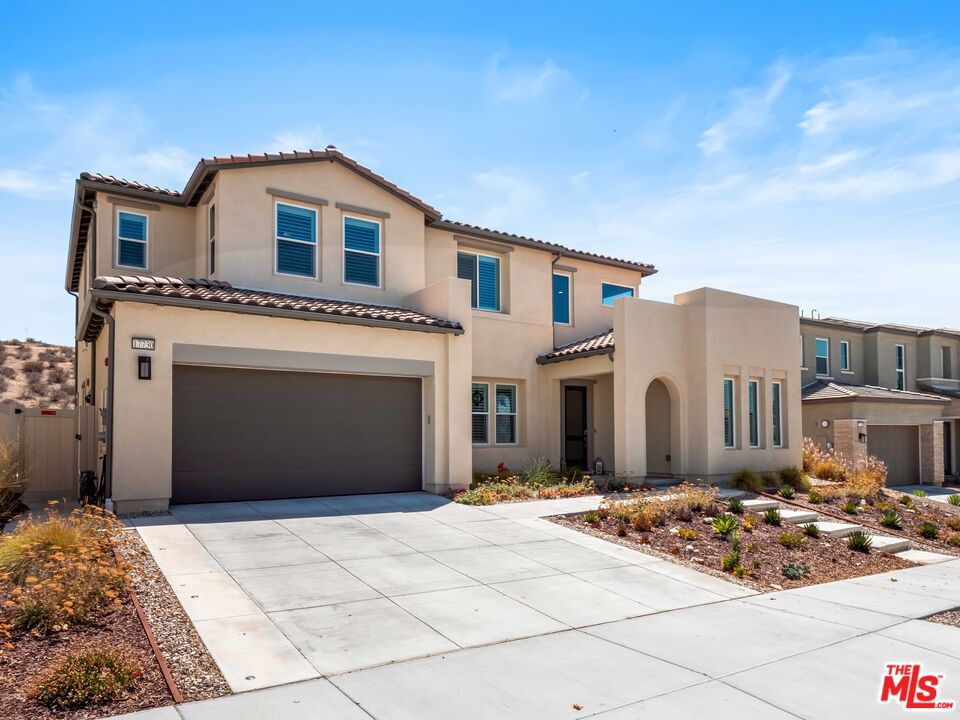 Stunning Brand-New 4 Bed, 4 Bath Skyline Home. This beautifully upgraded residence, located in the Starling neighborhood, features a downstairs ensuite bedroom, spacious bonus room, private office, airy loft, serene mountain and partial city views, owned solar panels, and an impressive list of high-end upgrades. The main level is designed for effortless entertaining, the open-concept layout centers on a chef's kitchen with a large central island, abundant cabinetry, and seamless flow into the dining and living areas. The living room showcases a sleek 72" linear fireplace with paint-grade mantel and slider opening to the covered patio. The bonus room is currently set up as a pool table room also connects to the yard. Additional features include a private office for work or study, a secondary powder room, mudroom, and a first-floor ensuite with upgraded tile. Head to the upper level and find a spacious loft which is perfect for a media or play area, while the laundry room offers a utility sink, storage cabinetry, and folding counter. All-optional cabinets throughout the home provide generous storage. The expansive primary suite boasts soaring ceilings, a private balcony with spectacular views, a walk-in closet, dual sinks, soaking tub, glass-enclosed shower, linen storage, and upgraded tile. Two additional bedrooms with raised-panel closet doors share a full bath with dual sinks. Interior Upgrades Include Smart TV pre-wiring in most rooms, whole-house sound insulation, upgraded flooring with premium padding and pet-friendly carpet, custom wood shutters and blinds, EV charging in the garage, and water softener plumbing. Outdoor Living with Low-maintenance, drought-tolerant landscaping front and back with decorative pavers, firepit, jacuzzi, covered patio, ample side yard space, widened driveway, Wi-Fi exterior lighting with holiday light package, and stunning views. The community includes kid's parks, dog parks, resort-style pools, clubhouse, bocce ball, recreation centers, and multiple trail entrances all minutes from restaurants, grocery stores, and more. Loan is assumable at a 3.365% interest rate!!