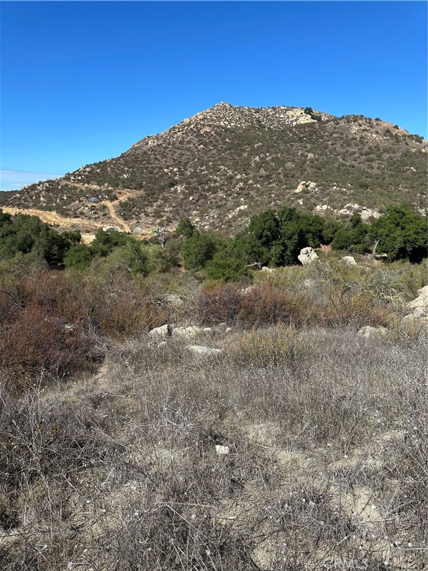 Gentle rolling to hilly 19.43 acres loaded with oak trees & decorative rock outcroppings, has seasonal creek, perfect for custom/manufactured home with great views. Power & transformer in front of parcel, also phone in the street. Close to Temecula Valley Wine Country & Vineyard's, close to Lake Skinner, Diamond Valley Lake & Vail Lake. For adult entertainment you are close to Pechanga Casino, Pala Casino, Soboba Casino.