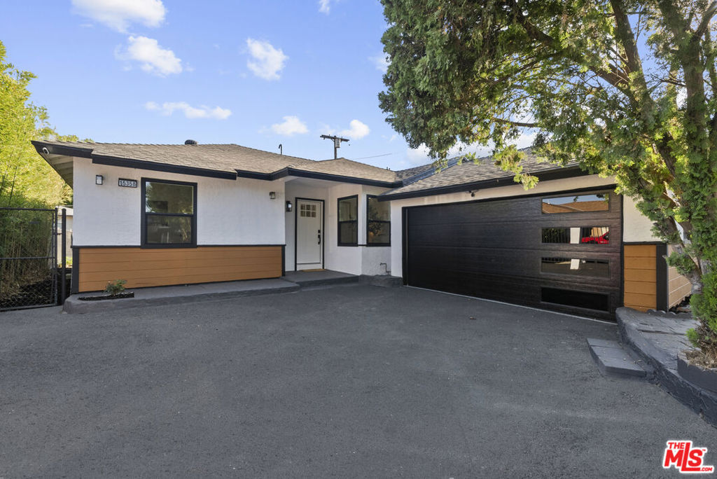 Welcome to this stunning, fully-gated modern masterpiece in Van Nuys, a home that offers the ultimate in privacy and functionality. Situated on a sprawling corner lot, this property is perfect for a first-time buyer or a growing family.Step inside and discover an open-concept layout that seamlessly connects the living spaces. The kitchen is truly the heart of the home, a fully remodeled showstopper where the gleaming quartz waterfall island and top-of-the-line stainless steel appliances make entertaining a breeze. You'll love the new custom cabinetry with under-mount lighting and the island's functional built-in USB ports and outlets, perfect for modern living and gathering with friends and family. Off the kitchen is a formal dining area that is perfect for entertaining.The versatile layout includes a spacious primary bedroom with a luxurious en suite bathroom and two additional, well-sized bedrooms. Both the primary and guest bathrooms have been completely renovated with new tile, vanities, and fixtures, creating a spa-like feel. You'll find new waterproof vinyl flooring, recessed lighting, and modern fans throughout the home, adding to the clean, contemporary aesthetic. The separate laundry area and newer water heater complete this truly turnkey opportunity.This home is designed for flexible living. A versatile bonus room can easily become a studio, playroom, or a fourth bedroom. Plus, a dedicated home office provides a quiet space for remote work. Outside, the expansive backyard is a blank canvas just waiting for your personal touch. Mature trees create a tranquil setting, while the back area is ideal for dining al fresco. The thoughtful dusk-to-dawn outdoor lighting creates a warm, inviting ambiance for evening gatherings.Every detail has been addressed for your comfort and peace of mind. The home features a newer central HVAC and heating system w/ Nest thermostat, a new 200-AMP electrical panel, and updated plumbing. A newer shingle roof and double-pane, tinted windows ensure energy efficiency and privacy. The freshly painted exterior, newly paved driveway, and modern garage door with an opener create instant curb appeal.For investors, this property offers a prime opportunity. The garage has been fully updated with new drywall, interior paint, sensor lights, and a durable epoxy floor, making it perfectly poised for conversion into an Accessory Dwelling Unit (ADU). With the new electrical panel and plumbing already in place, you can easily create potential rental income or a private guesthouse.Parking is never an issue with a gated driveway offering ample space for all your vehicles. Don't miss your chance to own this fully renovated Van Nuys gem, where modern elegance meets comfort and convenience.