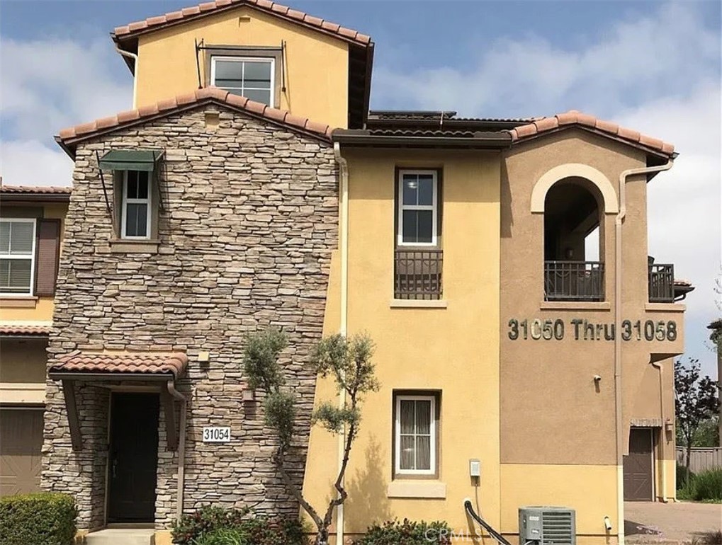 Welcome to the heart of Temecula! This beautifully designed tri-level townhome offers 2 bedrooms, 2 bathrooms, and a flexible layout that fits a variety of lifestyles. Enter through your private, attached two-car garage—complete with an EV charger for added convenience. On the second floor, the main living area features soaring 20-foot ceilings, expansive windows that fill the space with natural light, and modern finishes throughout. This level also includes a spacious bedroom, a full bathroom, and a versatile bonus room—perfect as a home office, den, or easily converted into a third bedroom. The open-concept layout flows effortlessly from the kitchen into the dining and living areas, ideal for both entertaining and everyday living. On the third floor, you'll find the private primary suite, offering a large bedroom, walk-in closet, and an en-suite bath with dual vanities. Located in the sought-after Temecula Lane community, residents enjoy access to resort-style amenities including a sparkling pool, spa, clubhouse, and more. With shopping, dining, Pechanga Casino, and freeway access just minutes away, everything you need is close at hand. Bonus: the home comes with fully paid-off solar! Don’t miss your opportunity to own this stylish and energy-efficient home—schedule your private showing today!