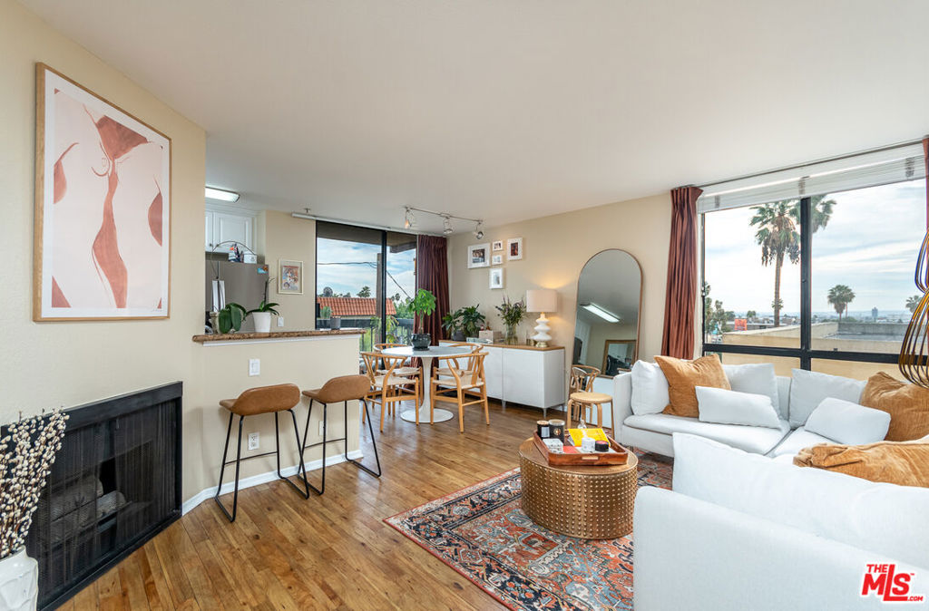 Bright corner unit with views in the highly sought after Hollywood Regis! This is not ground level unit! No one below you. Open layout concept. Kitchen features granite counters and S/S appliances. Large bedroom and bath, hardwood style floors, fireplace, balcony, only 1 shared wall and no one below you, great natural light, in-unit laundry, central heat and A/C and 2 parking spaces in the garage! Resort style building with heated pool, hot tub and gym. Runyon Canyon, shopping, restaurants and more within minutes. The HOA has a 25lb weight restriction for pets. Building has EV chargers for residents. Available Oct 1, 2025
