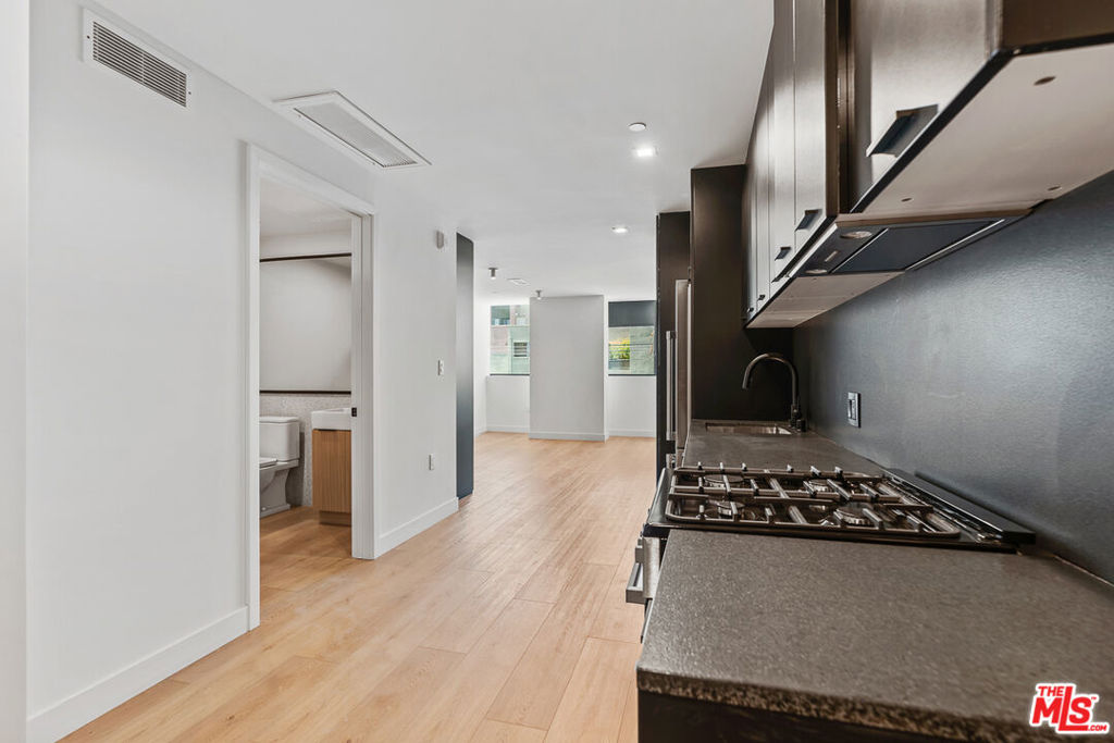 Venue Residences by Helio. This corner studio apartment is on the 2nd floor with West facing views. Kitchen has unique dark finishes with stained granite counters, matte black fixtures, and stainless steel Beko appliances including fridge, dishwasher, and gas stove. The living area has recessed lighting, blackout window shades, and a custom wall closet. The bathroom has a wall-to-wall mirror, under sink storage, and shower/tub. Property amenities include: Fitness center with Technogym equipment, co-working spaces, front desk staff, and 2 rooftop lounges with an outdoor cooking area and heated dipping pool. Off-site parking available for $125/month. Internet $84/month. Tours available after August 3rd. Contact us today!