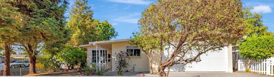 This beautiful 4-bedroom, single-level home sits on a 7,000 sq. ft. corner lot, offering seamless indoor-outdoor living. Vaulted high ceilings and skylights fill the interior with natural light, while large double-pane windows frame scenic outdoor views. All bedrooms are well-sized, with two opening to a serene backyard featuring fruit trees and partial mountain views. A standout 350 sq. ft. bedroom with a soaring ceiling and custom bar offers flexible use as a private suite, entertainment space, or meditation retreat. An expansive side yard invites endless possibilities, from a vegetable garden to a play area or relaxing outdoors. Laminate and tile flooring extends throughout the home, and the kitchen features solid wood cabinetry and granite countertops. Additional amenities include an attached two-car garage, spacious driveway, laundry room, and abundant storage. Enjoy easy access to top Bay Area employers, just minutes from I-680, I-880, CA-237, and BART (one hour to San Francisco). With a Walk Score of 72, shopping, dining, and parks are all within reach. Highly rated schools: Alexander Rose Elementary (6/10), Rancho Milpitas Middle (7/10), and Milpitas High (9/10) complete this South Bay residence, a rare blend of location, versatility, and lifestyle.
