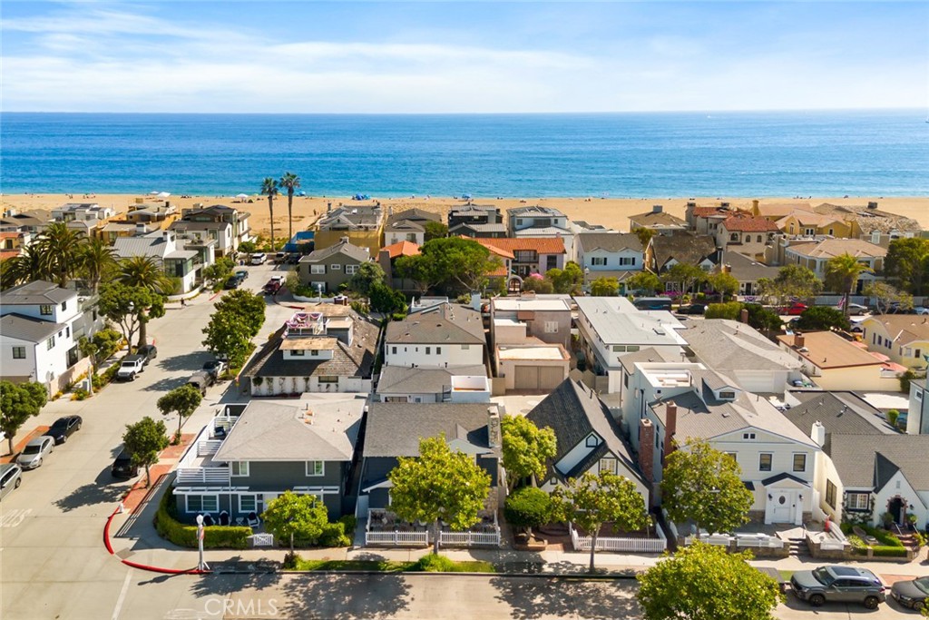 Nestled in the heart of Newport Beach’s coveted Balboa Peninsula, just two blocks from beaches along the Pacific Ocean and nearly as close to Newport Bay, this exceptionally upgraded and remodeled home is destined to enhance your lifestyle. Stroll to fashionable cafés, restaurants, shops and galleries, or relax at home on your inviting front patio, complete with a classic white picket fence. Beyond the Dutch entry door, a reimagined first level reveals open-concept style with a seamless dining room, living room and kitchen. A custom mantlepiece and white stone hearth grace a corner fireplace, while the new kitchen opens to the dining room with a passthrough bar and hosts Shaker cabinetry, stainless appliances, quartz countertops and a door to the side yard. Elegant craftsmanship is revealed through the inclusion of crown molding, wide white oak-inspired luxury vinyl plank flooring, designer lighting fixtures and custom wall treatments. Approximately 2,630 square feet, the four-bedroom, three-bath residence continues indoor/outdoor living on the second level, where a private deck is accessed by a versatile den, the primary suite and a secondary bedroom with separate entrance, making it perfect for guests. A spiral staircase leads from the main deck to a sunny rooftop deck with panoramic city-light views, and both decks are finished with slotted wood flooring. The primary suite showcases a sitting area, wood-finished accent wall, a romantic fireplace with floating hearth, a spacious dressing area with mirrored wardrobes, and a new custom bath with rain shower, freestanding tub and dual sinks. Further enrichments are led by recessed LED lighting, upgraded windows and sliding-glass doors that bathe interior spaces in natural light, a fresh white color palette, and an attached two-car garage. Close to The Wedge, a world-renowned surf spot, and minutes from Fashion Island, Balboa’s pier and Fun Zone, scenic parks, golf courses and luxury resorts, this turnkey home presents the ultimate mix of style, functionality and proximity to the water.