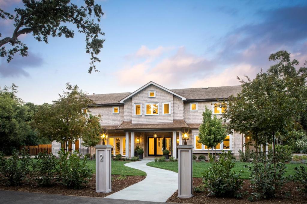Just completed new construction, this Hamptons-inspired estate with transitional and contemporary design offers airy and light-drenched spaces on three levels. The property has a total of six bedroom suites in the main residence plus two bedrooms and one bath in the Guest House/ADU. It is rich with amenities including an elevator, six heating/ac zones, heated floors in the primary bath, a vast lower level with a tiered theater, sauna, steam shower, bedroom or fitness suite, and full kitchen with bar, a detached guest house/ADU and pool with spa and outdoor kitchen. The property is located in close proximity to exceptional Atherton and Menlo Park private & public schools and Stanford University and has easy access to the 101 tech corridor and San Francisco and San Jose International Airports. Built by Yaeger Construction.
