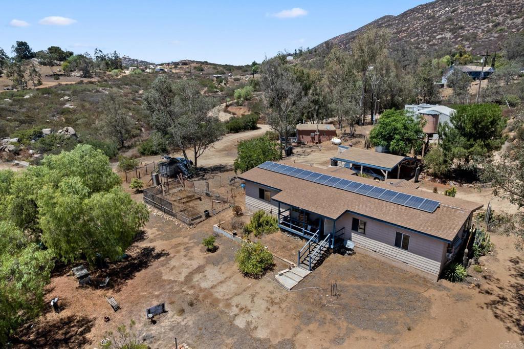 5 acres with a permitted 1600 SF warehouse. Well with 10k storage tank (permits unknown) 1976 trailer connected to septic (permits unknown) roof redone on trailer 5 years ago. A bonus detached studio/art room with covered patio (permits unknown) $20k solar system included owned (permits unkown) Unique property not far from town and short distance off Highway 94 with ample room for storage and RVs. Across the flume is additional property that can be graded for more usable land included in the 5 acres. Elec, septic and well all function permits unknown. **CASH ONLY** **Buyers advised to independently invistage all aspects, permits, property use etc before closing and potential issues with county.