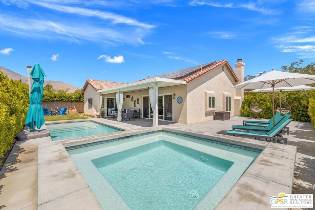 Wow! Reimagined in 2024, this Palm Springs contemporary is packed with upgrades, style, and effortless cool. San Jacinto Mountain views, a versatile bedroom count, and owned SOLAR are standout features. The newer pool and spa make a bold statement too! This corner property's ultra-private backyard sets the scene for fabulous entertaining with the pool's Baja bench tanning shelf, while the spacious 10x10 spa is pure joy. Several inviting spots around the pool make it easy to relax or entertain like a pro. Inside, the open-concept living space shines. Vaulted ceilings in the living room amplify the natural light, creating a bright and airy atmosphere. The kitchen nails it with sleek, modern finishes, and brand-new water-resistant Pergo hardwood floors run throughout, combining style with serious durability. The ensuite primary is a pleasant retreat with direct patio access, a revamped bathroom featuring a dual shower, and a walk-in closet outfitted with built-ins. Bedrooms Two and Three share a renovated hall bath, and Bedroom Four doubles as a stylish office. All-new windows and sliders, an attic fan to keep things cool when the desert heats up, and a utility room with direct access to the two-car garage add to the home's functionality. The garage is future-ready with two 240v EV charging outlets and drop-down attic access for extra storage.Just minutes from the buzz of Uptown Palm Springs' shops and restaurants, this fantastic home on FEE LAND (you own it) is currently eligible for a SHORT TERM RENTAL permit! Check out the Matterport virtual tour and see why this one stands out.