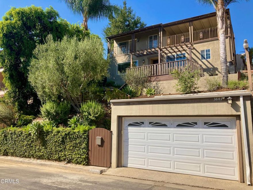 Tucked high in the scenic hills of Glassell Park, this inviting 3-bedroom, 3-bathroom home spans nearly 2,000 sq. ft. and offers sweeping city skyline and rolling hillside views. Thoughtfully updated throughout, it perfectly blends indoor and outdoor living in one of Northeast LA's most desirable neighborhoods.On the main level, the open-concept living, dining, and kitchen areas are bathed in natural light from expansive windows framing the surrounding hills. The living room's decorative fireplace adds warmth and charm to the bright, airy space, while updated flooring throughout the downstairs enhances the home's modern appeal. The remodeled kitchen features contemporary finishes and stainless steel appliances ideal for everyday living and entertaining, plus the convenience of a walk-in pantry for ample storage. An ideally located half bath serves guests with ease.Upstairs, the spacious primary suite offers a spa-style bath featuring a separate shower, soaking tub with city views, walk-in closet and French doors opening to a serene private patio. Refinished hardwood floors flow throughout the upper level, adding warmth and character. A second bedroom opens to a breezy balcony with tranquil hillside views, while a third bedroom with direct outdoor access and remodeled second bath complete the upstairs.Outdoor living shines with a multi-level backyard ideal for entertaining. The spacious deck functions as a complete outdoor kitchen with BBQ and refrigerator, plus built-in table and bench seating to enjoy stunning city views while dining al fresco. Tranquil sitting spaces, garden beds ready for planting, and lush landscaping create a sense of privacy and retreat. A detached garage at street level completes the property's thoughtful and functional layout.Centrally located near Eagle Rock, Highland Park, Glendale, Mount Washington, and just minutes from DTLA, this Glassell Park gem offers hillside charm with unmatched convenience.Please note: Bedroom pics are virtually staged to protect the privacy of the tenants.