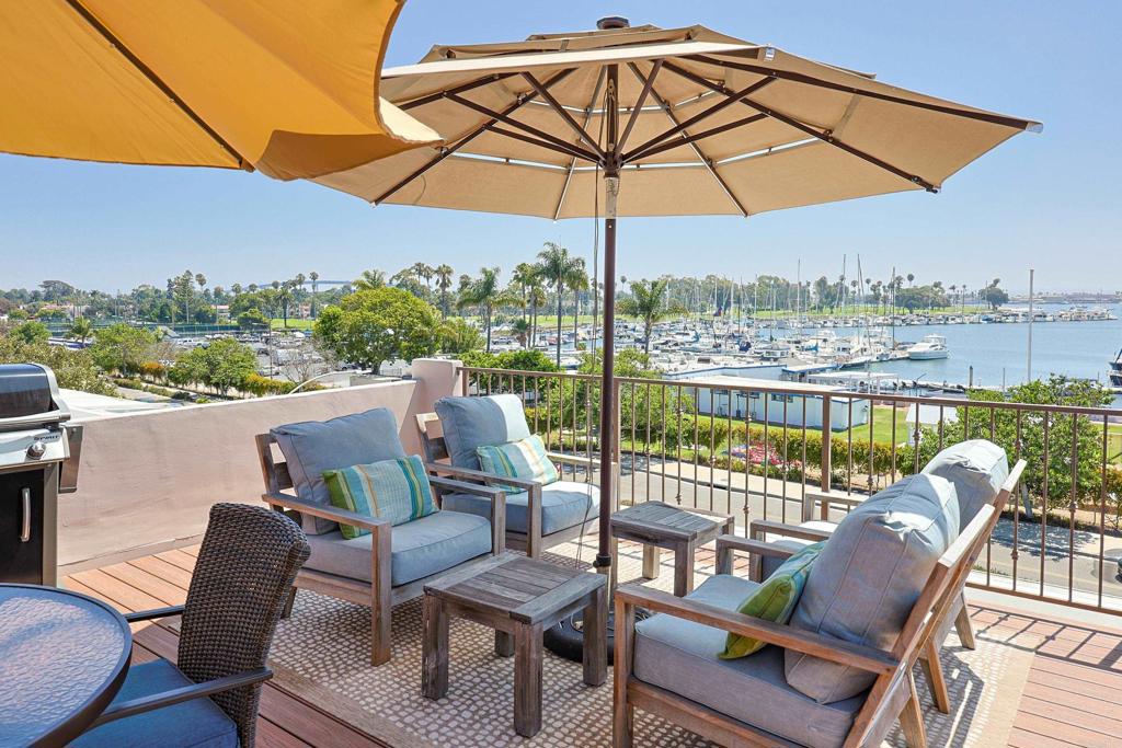 FURNISHED SHORT TERM RENTAL Exquisite Coastal Escape on Coronado Island Indulge in the ultimate seaside getaway at this stunning 2-bedroom, 2-bathroom home, perched above the sparkling waters of the Bay and overlooking the prestigious Coronado Yacht Club. Just moments from the beach and the iconic Hotel Del, this fully remodeled retreat blends modern elegance with relaxed, beachy charm. Step onto the expansive rooftop deck to savor panoramic views, entertain with the BBQ grill, or simply unwind in the sun with ample seating. Inside, every detail has been thoughtfully curated—from the stylish, light-filled interiors to the modern amenities including air conditioning, heating, and in-unit laundry. Perfect for families, couples, or friends seeking a sophisticated escape, this home offers a seamless blend of comfort, style, and convenience, complete with one assigned parking space. Experience Coronado living at its finest—where luxury, coastal beauty, and effortless relaxation meet. Sorry, no pets. Owner is highly allergic. Fireplace is non operable.