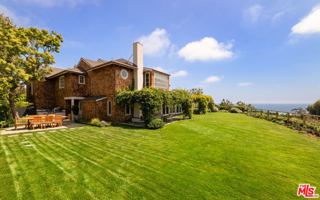 Situated behind gates this traditional East Coast shingled home boasts spectacular ocean views, beautiful gardens, and total privacy. Located on one of the Westside's most prestigious streets with a large living room w/ high beamed ceiling, gourmet kitchen w/ large center island, open family room, and formal dining room all with French doors and windows opening to a spectacular gardens, outdoor loggia in an idyllic setting all overlooking stunning ocean views. Beautiful primary suite and guest/family bedrooms creating the perfect environment.