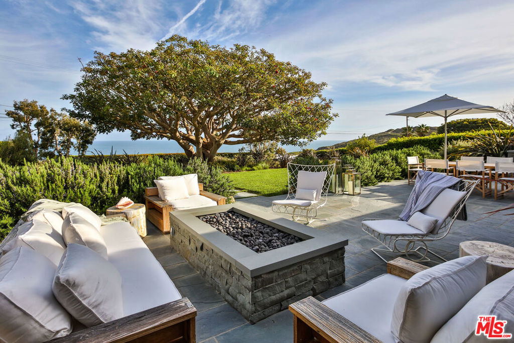 Magical Point Dume Compound tucked behind private gates on coveted Cliffside Drive with unobstructed ocean views from nearly every room. This lush, resort-like retreat is directly across from the Point Dume Headlands and offers the ultimate Malibu lifestyle. Designer furnished and professionally decorated to perfection, the interiors evoke the feel of a boutique hotel. Outside, the property flows seamlessly with a deep kidney-shaped pool, tennis court with/ night lights, treehouse, outdoor BBQ area and fire pit, all surrounded by mature, tropical landscaping and a huge enclosed yard. Steps to the beach, with hiking trails, whale watching, restaurants, and amenities just minutes away. Truly a spectacular property.