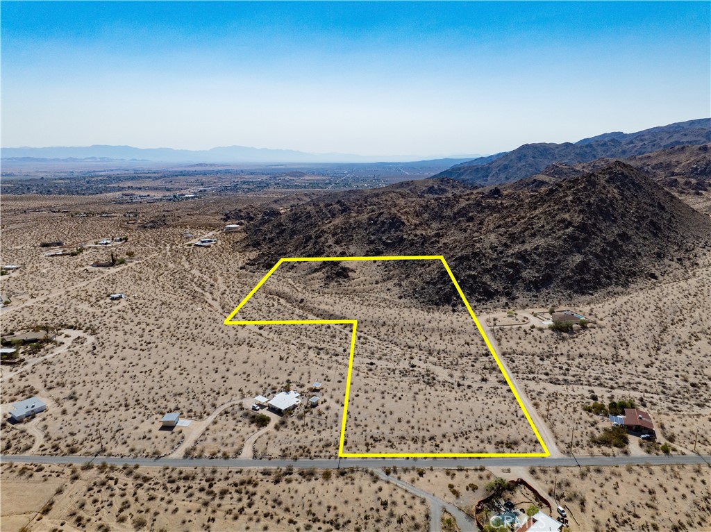RARE OPPORTUNITY TO OWN 15+ ACRES JUST OUTSIDE JOSHUA TREE NATIONAL PARK! This listing is for three adjoining parcels being sold together, each just over 5 acres. The lots are easily accessible off the corner of Canyon Road and Foothill Drive in the peaceful and scenic Sherman Heights area of 29 Palms. These lots are so close to the national park that one of them is literally bordered by it directly to the south and east – not only that, but the 49 Palms Oasis hiking trail is right outside your door. You might think the serenity of the location means inconvenience, but you'd be wrong – you're just a short distance from pavement here, with the amenities of 29 Palms less than 10 minutes from this location and charming Joshua Tree Village only a few minutes more to the west, allowing you to easily access the shops and restaurants of either community. Incredible views surround you here – to the south, the rugged mountains of JTNP command your nearby view, while wide open panoramas of the entire Morongo Basin stretch out in every other direction. You'll be pleased to note that utilities appear to be available nearby, and the property looks to be free of protected desert plants, meaning building your dream home should be all the easier (buyer to verify all utilities and land use). Come see this rare find and you'll know right away this is the land you've been looking for.