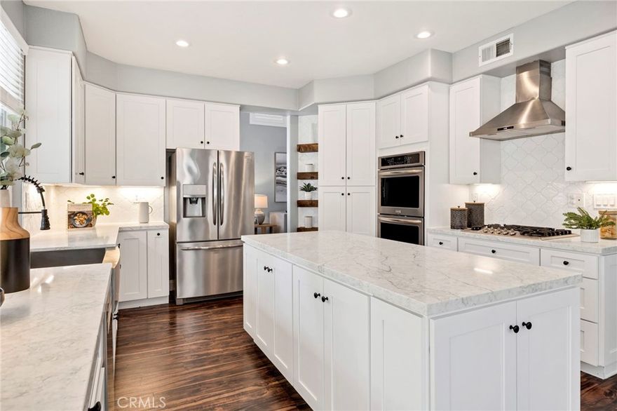 Discover this beautifully updated 5-bedroom, 3-bath pool home in the desirable Redhawk neighborhood of Rancho Palomar. This home is where Temecula lifestyle meets luxury and value being one of the lowest HOA and tax rate neighborhoods in Redhawk. Pride of ownership abounds in this open-concept living residence, offering owned solar, modern upgrades, high ceilings, and abundant natural light throughout. Step into a remodeled kitchen that will impress even the most discerning buyers with white shaker soft close cabinetry, quartz countertops, a modern range hood, gorgeous designer backsplash, floating shelves, stainless steel appliances and a large island open to the family room with a built in microwave, ideal for entertaining and everyday living. The home showcases LVP flooring, plantation shutters, neutral paint, brand new carpet in the bedrooms, and a bright, airy feel. Upstairs through a grand double door entry you will find a spacious primary suite which boasts vaulted ceilings, natural light, dual closets, and a 5 piece en-suite with a walk-in shower, double sinks, and a separate makeup vanity. The remaining three bedrooms with brand new carpet are just down the hall as well as a shared bath with a double sink vanity, plus a flex/loft room that can easily serve as a 6th bedroom, home gym, playroom, or theater for movie nights at home. Back downstairs you will find another full bedroom and full bath, perfect for multi-generational living, guests, or a home office. Enjoy parking your cars in an epoxy-finished 3 car garage with an EV charger, modern workspace, and storage. The large and spacious backyard offers room to relax or entertain with a heated pool that was resurfaced and retiled 1 year ago with a StoneScapes Pebble lifetime warranty, spa, new pool equipment, Crepe Myrtle trees, and a lush green lawn perfect for mini soccer games, backyard BBQ entertaining, or even a volleyball court. The manicured front yard exudes curb appeal, with low upkeep! Located minutes from the I-15 freeway in the desirable South Temecula area, this home offers an easy commute to San Diego or Orange County, making it perfect for buyers seeking more space, top-rated schools, and a high-quality lifestyle with nearby amenities. Zoned for the acclaimed Great Oak High School, and close to shopping, dining, Temecula Creek Inn, the Redhawk Golf Course, Pechanga, Old Town, and Temecula’s famous wineries, this home is well appointed and ready for holiday entertaining!