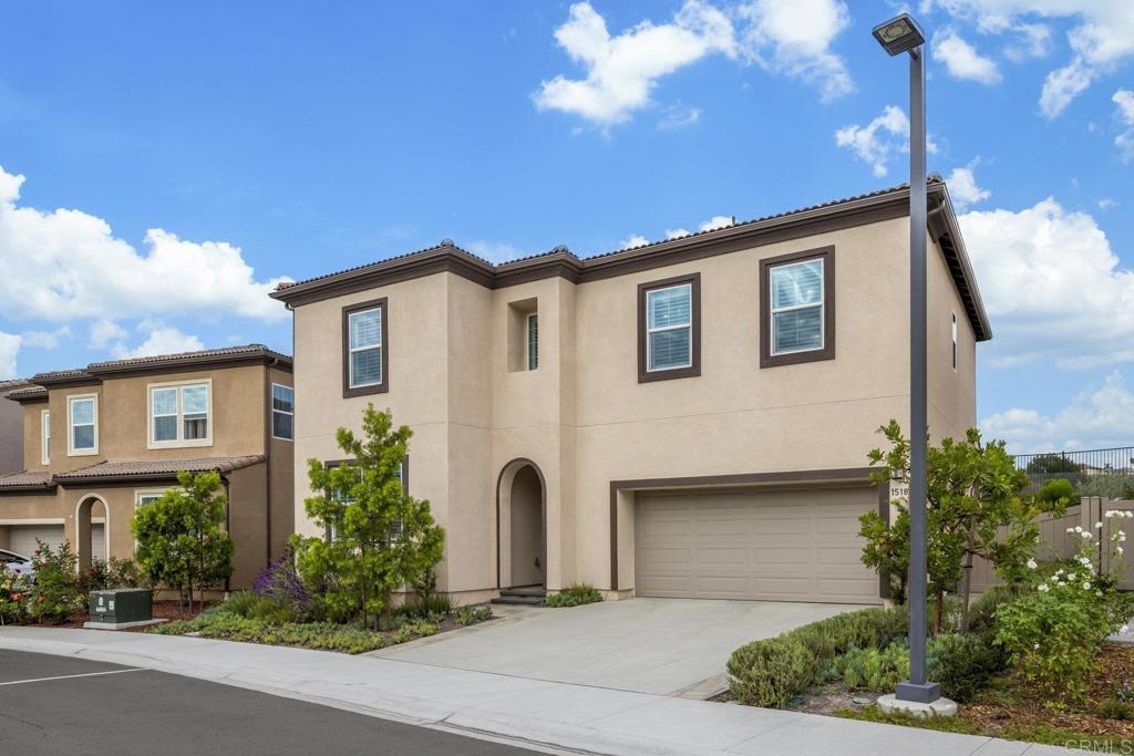 Welcome home to 1518 Pepperwood Way in the highly sought-after Neptune enclave of Melrose Heights. This immaculate single-family home was completed in by Trumark Homes and showcases 2,427 square feet of beautifully designed living space with 5 bedrooms and 4 full bathrooms, including a downstairs bedroom and full bath ideal for guests or multigenerational living. Throughout the home, wide-plank, wood-grain textured luxury vinyl plank flooring provides a cohesive and low-maintenance design element that extends into all bathrooms, closets, and even the stairs. The open-concept main level is anchored by a spacious great room and a chef-inspired kitchen outfitted with shaker-style cabinetry, pendant lighting, a Bosch professional 5-burner gas range, high-BTU microwave/vent hood, and a Samsung Bespoke 4-door refrigerator with interchangeable stainless panels. The expansive primary suite offers a luxurious retreat with a deep soaking tub, separate walk-in shower, private water closet, and a generous walk-in closet. A sizable secondary en-suite bedroom—currently used as a media room—adds flexibility, while two additional bedrooms share a well-appointed full bath. The large upstairs laundry room includes side-by-side washer and dryer, ample cabinetry, and plenty of folding space. The home is loaded with thoughtful upgrades such as custom plantation shutters on every window, blackout shades in three bedrooms, increased LED recessed lighting in bedrooms, kitchen, and family room, additional cabinetry in the laundry room, upgraded shower fixtures in all bathrooms, and pre-wiring for ceiling fans in the primary suite and main living area. Energy-efficient features include 10 owned solar panels and a 240V outlet in the garage for your electric vehicle charger. Outdoors, the professionally designed landscaping includes Belgard pavers in the front entry, driveway borders, and a contemporary backyard layout complete with retaining walls, mature native plantings, and enjoy entertaining with a custom-built BBQ island featuring a stainless steel Bull grill, outdoor refrigerator, and 6-person spa with a deluxe hard-top cover. Surrounded by the natural California chaparral, hills and rocks providing the perfect atmosphere to enjoy the sunsets and relax peacefully. Experience this rare opportunity to own a nearly new, turnkey home with designer finishes, premium upgrades, and incredible indoor-outdoor living close to beaches, shopping, dining and the vibrant Oceanside lifestyle!