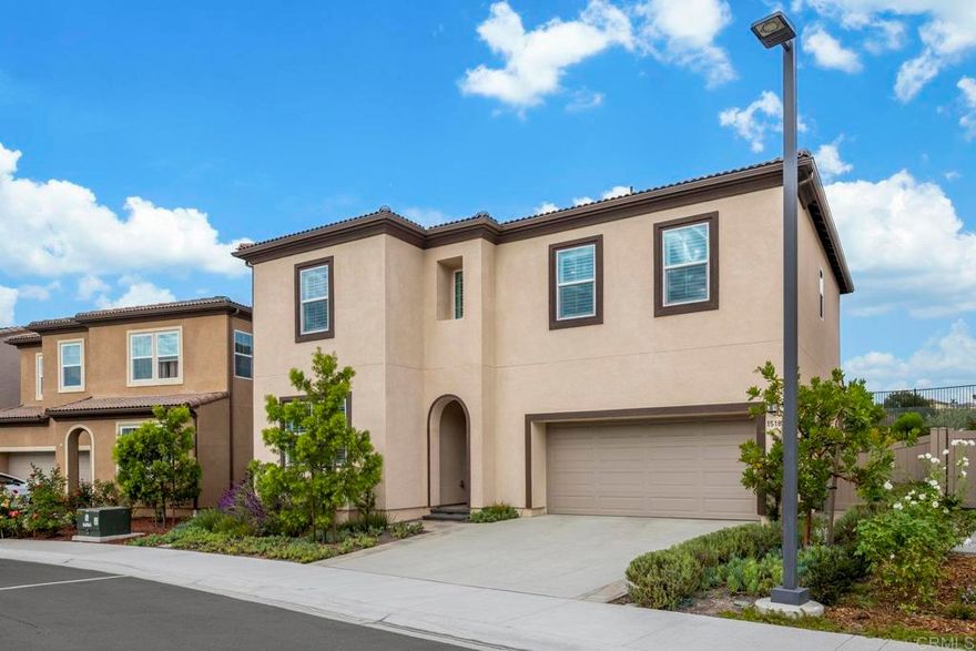 Welcome home to 1518 Pepperwood Way in the highly sought-after Neptune enclave of Melrose Heights. This immaculate single-family home was completed in  by Trumark Homes and showcases 2,427 square feet of beautifully designed living space with 5 bedrooms and 4 full bathrooms, including a downstairs bedroom and full bath ideal for guests or multigenerational living. Throughout the home, wide-plank, wood-grain textured luxury vinyl plank flooring provides a cohesive and low-maintenance design element that extends into all bathrooms, closets, and even the stairs. The open-concept main level is anchored by a spacious great room and a chef-inspired kitchen outfitted with shaker-style cabinetry, pendant lighting, a Bosch professional 5-burner gas range, high-BTU microwave/vent hood, and a Samsung Bespoke 4-door refrigerator with interchangeable stainless panels.  The expansive primary suite offers a luxurious retreat with a deep soaking tub, separate walk-in shower, private water closet, and a generous walk-in closet. A sizable secondary en-suite bedroom—currently used as a media room—adds flexibility, while two additional bedrooms share a well-appointed full bath. The large upstairs laundry room includes side-by-side washer and dryer, ample cabinetry, and plenty of folding space. The home is loaded with thoughtful upgrades such as custom plantation shutters on every window, blackout shades in three bedrooms, increased LED recessed lighting in bedrooms, kitchen, and family room, additional cabinetry in the laundry room, upgraded shower fixtures in all bathrooms, and pre-wiring for ceiling fans in the primary suite and main living area. Energy-efficient features include 10 owned solar panels and a 240V outlet in the garage for your electric vehicle charger.  Outdoors, the professionally designed landscaping includes Belgard pavers in the front entry, driveway borders, and a contemporary backyard layout complete with retaining walls, mature native plantings, and enjoy entertaining with a custom-built BBQ island featuring a stainless steel Bull grill, outdoor refrigerator, and 6-person spa with a deluxe hard-top cover. Surrounded by the natural California chaparral, hills and rocks providing the perfect atmosphere to enjoy the sunsets and relax peacefully.  Experience this rare opportunity to own a nearly new, turnkey home with designer finishes, premium upgrades, and incredible indoor-outdoor living close to beaches, shopping, dining and the vibrant Oceanside lifestyle!