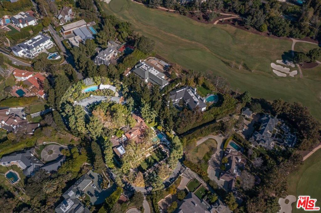 Now offering entire 1.5-acre compound that includes 2 lots and 2 houses. Set behind private gates on the only island in Bel-Air, flanked between the East and West gates close to Sunset and UCLA in an exclusive cul-de-sac protected by heightened neighborhood security and a dedicated Perugia Way guard. Not seen for more than half a century, Il Sogno "The Dream" is a magnificent Tuscan Villa representing a once-in-a-generation opportunity to own this special estate. The compound is nestled away from the bustle of Sunset, yet conveniently situated minutes from Westwood and Beverly Hills. A landscaped, circular motor court surrounded by towering trees leads into 500 Perugia Way. This 5 bedroom + maid's, 7 bathroom + 2 powder, 10,607sf classic Villa was built by Mark Daniels with superb interiors by Kalef Alaton, who created an authentic Italian villa using Tuscan and Amalfi coast artisans. A dramatic foyer flows into the formal living room with fireplace and ornate, hand-painted ceiling. An indoor-outdoor ambiance pervades with floor-to-ceiling arched French doors that open onto a serene veranda. Antique plaster walls, 6 stone-carved fireplaces, and endless world-class details transport into an era of elegant romance. The petit salon flows into the unique l'Orangerie, a spectacular entertainment space with vaulted glass ceiling, bar, and fireplace. The Red Library showcases an intricately painted skylight. The master bedroom suite displays Italian hand-painted frescos designed by Claudio Briganti adorning the domed ceiling, walls, and wood floors, a private patio and dual bathroom suites with onyx, custom cabinetry, walk-in closets, and sitting area. The formal dining room showcases floor-to-ceiling windows and French doors that open to a loggia for alfresco dining. The breakfast room's walls feature captivating mirror/decorative panels inspired by the Caff Florian in Venice, adjacent to the chef's kitchen with island and state-of-the-art appliances. The second floor is encompassed by 2 bedroom suites and a secondary master suite/family room with wood-beamed ceiling, fireplace and terrace. Throughout this lavish estate, grand rooms with beautiful scale overlook spectacular indoor/outdoor views of the ocean, skyline, Bel-Air golf course, UCLA, and the villa's gardens. The grounds, designed by David Jones, include a swimming pool, sunken grotto spa, fountains, enormous lawns, formal gardens, and specimen trees. Additional 500 Perugia estate amenities: 4-car garage, bonus space, lower-level wine cellar, 2 offices and gym with ensuite bathroom. A pathway could easily be added to connect 500 Perugia to 512 Perugia's tranquil Balinese-style cottage oasis. This 3 bedroom, 5 bathroom approx. 4900sf artisan curated haven offers maid's quarters and 1bd/1ba cabana. The romantic, wrap-around terrace harmoniously blurs the nature-filled scenery within the home. An idyllic lanai acts as a dreamy entertainment venue with its hand-painted walls and outdoor fireplace. Stairs ascend to an ultra-private swimming pool and cabana. Come experience the allure of Il Sogno's peaceful, enchanting surroundings