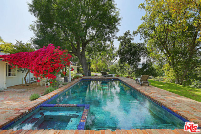 Enter through the celebrity enclave/gated community of Oak Pass Road to find an elegant private gated drive to this enchanting mid-century one story home. Featuring high vaulted ceilings, french doors, hardwood floors, spacious master suite with walk in closet and luxurious bath, enormous sun lit pool, tremendous natural light, and tranquil private half acre setting, this home is truly one of a kind. An ideal space for entertaining, enjoy incredible views of the beautiful natural scenery surrounding this truly private retreat. Have the feeling of no neighbors, yet enjoy the luxurious approach while being surrounded by $20,000,000 estates.