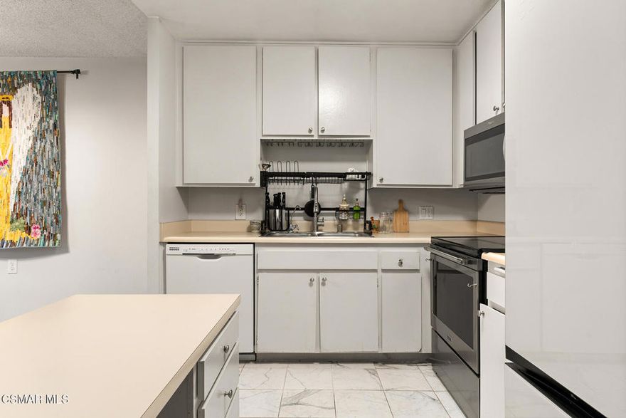 A Peaceful Corner Unit in Oaknoll Villas (55+)Nestled in the desirable Oaknoll Villas community, this 2-bedroom, 2-bath condo offers a convenient first-floor corner location with a spacious outdoor patio surrounded by open space--ideal for morning coffee, fresh air, and added privacy.Inside, the layout features an open-concept living, dining, and kitchen area with updated appliances and modern tile flooring. The primary bedroom includes an updated ensuite bathroom, while the second bedroom offers its own patio access through sliding doors and is serviced by a recently updated hallway bathroom with an expanded walk-in shower. The unit is thoughtfully positioned near the trash room, and the community laundry is just one elevator ride away. Laundry is efficiently scheduled--each unit receives two 2-hour reserved slots--making it simple and predictable to plan.The Oaknoll Villas community is beautifully maintained and surrounded by trees, mountains, and walking paths, creating a calm and welcoming environment. Amenities include a recreation center, gym, yoga room, library, billiards, shuffleboard, a private dog park, pool, spa, lounge areas, and outdoor BBQ facilities. The clubhouse may also be reserved for gatherings at a minimal cost. HOA dues include Wi-Fi, DirectTV, trash, landscaping, and earthquake insurance, adding both convenience and value. On-site management and well-kept grounds contribute to a peaceful living experience.The location offers easy access to hiking trails, shopping, dining, The Oaks Mall, and local conveniences--making daily life simple and enjoyable.The home is currently tenant-occupied, offering a choice: purchase with a reliable tenant in place for rental income, or take occupancy and make the space your own. One resident must be age 55+, but ownership is open to any legally eligible buyer.A great opportunity to join one of Thousand Oaks' most established and well-cared-for 55+ communities.