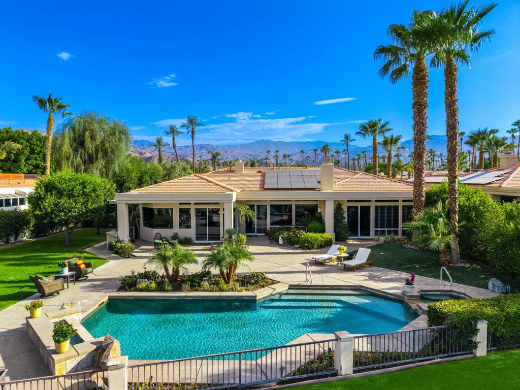 Open House Saturday 12 - 2pm! Price Adjustment on this fabulous home! Experience Luxury Living in this Stunning 4 Bedroom-5 Bath Augusta floor plan, perfectly situated on a spacious, oversized VIEW lot within Desert Horizons Country Club. Owned 30 panel Solar System and Furnished for your convenience, this home combines elegance and comfort. Enjoy breathtaking Panoramic Views of the serene Lake and the picturesque 13th Green, creating an idyllic backdrop. The home beautifully features a combination of Tumbled Travertine & Tile Flooring, 2 cozy Fireplaces, custom cabinetry, and soaring ceilings.The interior is designed for entertaining, with expansive Living Room/Family Room, Dining, and Wet bar areas that seamlessly connect. The updated Gourmet Kitchen is a Chef's dream, equipped with warm-finished cabinetry, Quartz Counters, Pantry and Top-of-the-Line Appliances such as Wolfe, Sub Zero, and Miele. The Primary Suite offers a spa-style bath, dual vanities, and a generous walk-in closet, while 2 additional Guest Rooms with en-suite baths provide privacy and convenience. A custom-built office, which can serve as a 4th bedroom, offers a perfect workspace. Step outside to the expansive entertaining Patio where captivating Mountain Vistas and scenic Fairway Views are yours. Enjoy the sparkling Pool and Spa, a custom BBQ area -ideal for relaxing or hosting memorable gatherings. The spacious side yard is landscaped with luscious Fruit Trees, Dining area, perfect for your furry friends and outdoor activities. Completing this stunning property is a 3-car garage with AC, Newer HVAC systems. Your ultimate desert lifestyle.