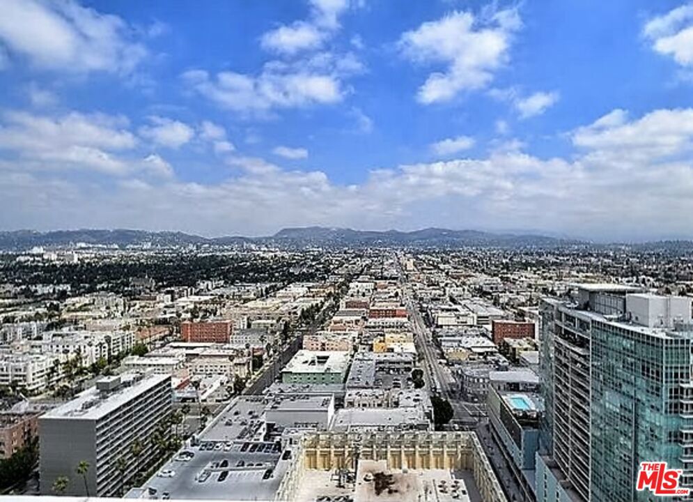 The most Desired & Spacious Corner Unit with Stunning Views on the North East corner in the Heart of Koreatown! Unobstructed city views from the private balcony. Unlike many floorplans in the building, full-sized two-bedroom residence with an ideal layout for both comfort and privacy.Granite Countertops and Island in the kitchen. Hardwood in the Living room and the bedrooms. Balcony with access through a sliding glass door and Double Pane Windows. 24 Hour lobby attendant and Security. Amazing Roof top deck with Fabulous views of City lights, Gorgeous Resort quality Pool and Spa, fully-equipped Fitness Center, Deck chairs & Tables. Two Side by Side Parking spaces and Community Guest parking. Across the street from the Metro Station, Theaters, many Shops, Restaurants and Markets... The Most Convenience Location in Korea-Town! Easy to show and available for move in.