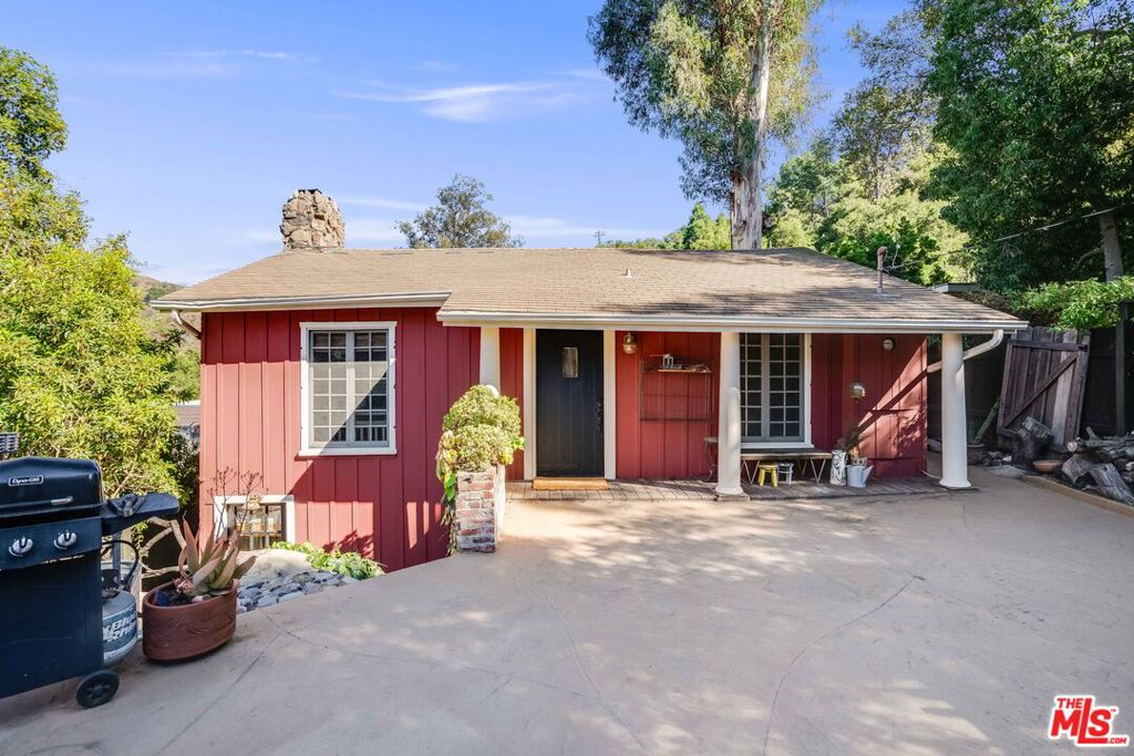 This character-filled 1920s Topanga cabin offers 2 bedrooms and 2 bathrooms, with stone fireplaces on both levels, a spacious kitchen and original details throughout. Two detached studios - one with a loft bedroom - and a large patio and deck space that connect them all provide a versatile indoor/outdoor living space amongst the multiple structures. Ideally located in the heart of Topanga, the property is just a short walk to cafes, restaurants, shops, the library, and the elementary school. It shares a fence with the Topanga Fire Station and is minutes from hiking trails and Topanga Beach. Enjoy intimate canyon views, an outdoor bathtub and shower, and a one-car garage. A private retreat that feels far from the city, yet close to everything you need.