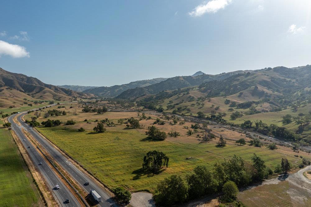 Large Ranch offered just 35 minutes from the Silicon Valley. This ranch consists of approximately 1130 Acres situated in the Foothills of the Diablo Mountain Range. The property has over a mile of Highway Frontage on Pacheco Pass Highway 152 near Casa De Fruta and over a mile of the Pacheco Creek running through the ranch. This ranch has multiple ponds, springs, creeks, and water features with vast rolling oak studded hills. Improvements include a 3,000 sqft modular home and a metal shop building. This is a one of a kind property very close to the Bay Area.