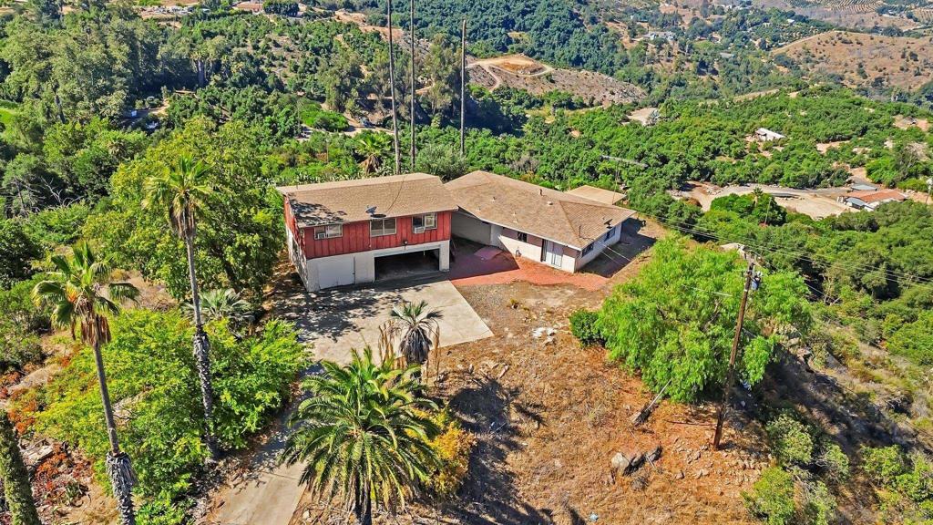 Welcome to 6133 Rainbow Heights Rd, an exceptional 4.25-acre investment opportunity in the sought-after hills of Fallbrook. Zoned Agricultural and offering 360-degree panoramic views, this unique property is perfect for those looking to capitalize on multi-family development, generational living, ADU additions, or flip projects. Featuring two existing fixer units, the lot presents immediate upside for investors or owner-builders. Renovate and resell the existing 2bd 1ba detached home and 1bd 1ba ADU, add units for rental income, or design a custom estate with multiple dwellings, the flexibility is unmatched. With existing utilities on site, the path to development is already in motion. Surrounded by custom homes and tucked in a peaceful setting, this is the kind of property where vision becomes reality. Located in the 92028 zip code and just minutes from downtown Fallbrook, Temecula wine country, and North San Diego County, you’ll enjoy easy access to shopping, dining, and freeways while still savoring rural charm. Whether you're building a multi-generational retreat, creating an income-producing property, or searching for a high-upside flip opportunity, this is a rare find in one of Southern California’s most promising investment pockets.