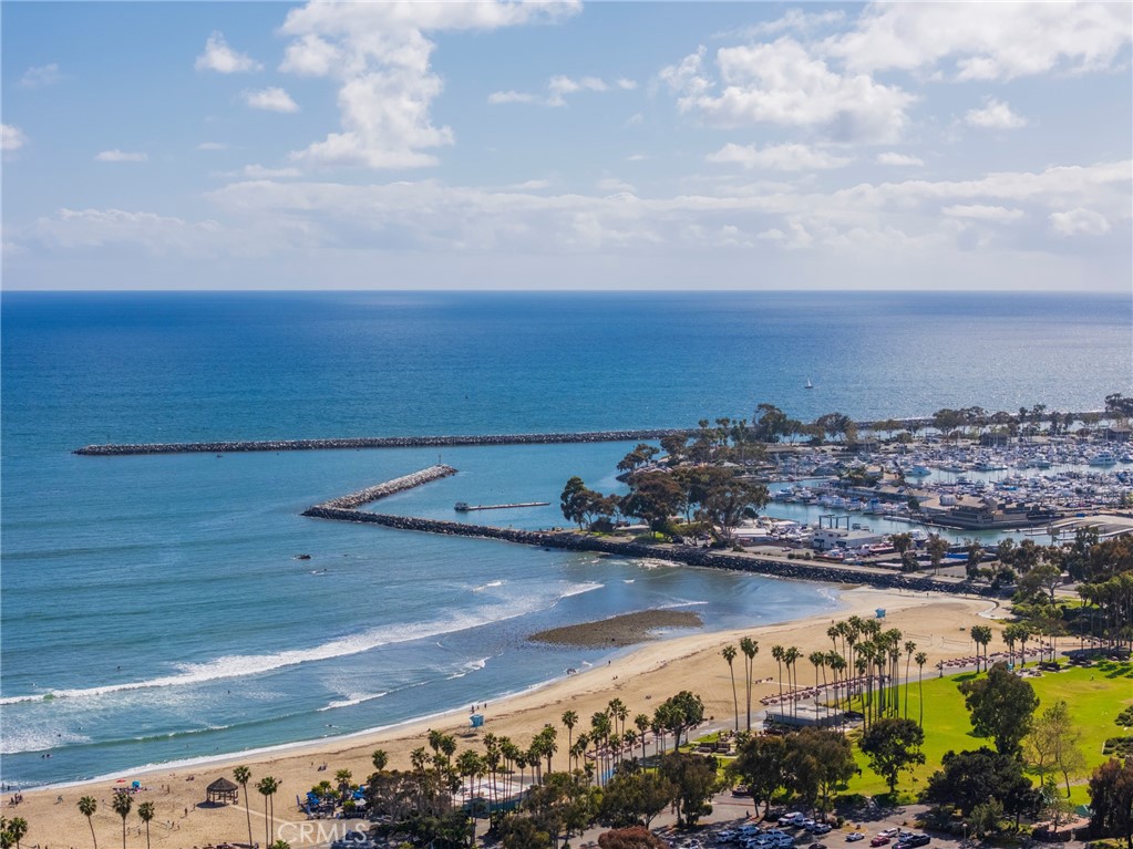 Welcome to your beautifully updated ground-level apartment located in one of Dana Point’s most desirable coastal neighborhoods—just across from iconic Doheny State Beach and a short stroll to Dana Point Harbor. This charming unit offers unbeatable convenience, with world-class dining, boutique shopping, and endless outdoor activities all within walking distance. Step inside to find a thoughtfully refreshed living space featuring modern finishes and a clean, open layout designed for both relaxation and everyday living. While this ground-floor unit doesn't offer an ocean view, it more than makes up for it with its unbeatable location and polished interior. Enjoy access to the community patio—ideal for outdoor dining, relaxing with a good book, or hosting a cozy BBQ. All utilities are included, except for cable, making this an easy and stress-free choice for your next home. Don’t miss this rare opportunity to live steps from the beach and harbor in beautiful Dana Point