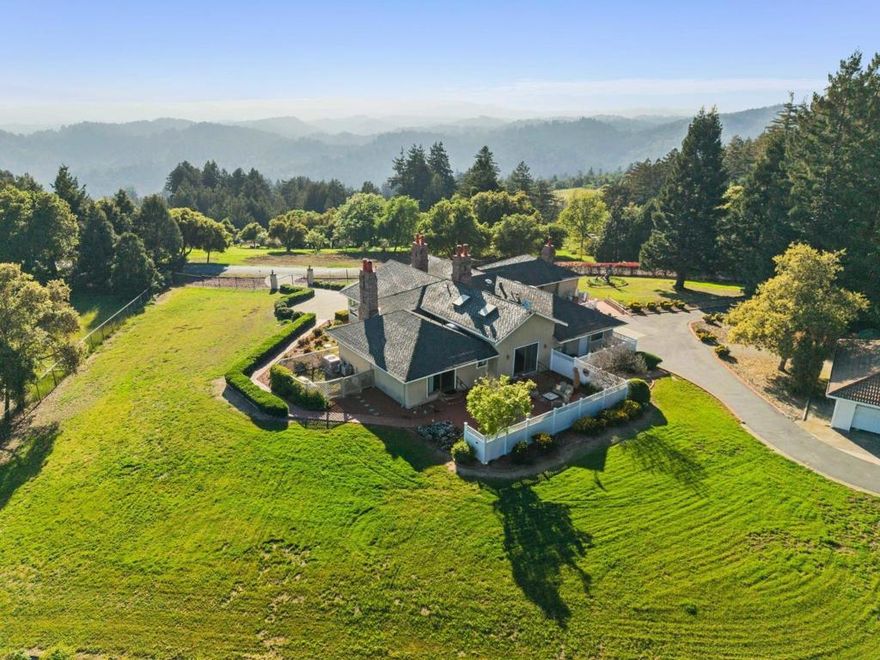 A locally famous dinosaur sculpture park greets you at this exceptional mountain estate, boasting 270 degree panoramic mountain & bay views! Sunny, flat/gently sloped acreage offers an abundance of usable land to add an ADU, orchard, vineyard, horses, sport court, pool etc. The interior centers around a stunning remodeled kitchen with custom cabinetry, gorgeous quartz counters, incorporating breakfast dining, all open to the cozy den with brick fireplace. Oak beams, paneling & moldings showcase custom craftsmanship throughout the home. Separate formal dining & living rooms with panoramic views, flank the grand entry hall. Entertainers will love the recreation room with bar, display cabinetry and shelving for your liquors/glasses. The primary suite features a remodeled oversized stall shower and sunny deck. 2 further beds and full bath in the opposite wing. Attached 2 car garage plus detached garage/workshop with loft. Automatic gates at the main entry with paver driveway, an alternative 'tradesmans entrance' opens to a circular driveway to the back door/laundry room, then exits onto Skyland. Beyond the expansive lush lawn is a natural meadow/pasture. 'The dinosaurs' are a popular, local landmark, much loved by the local mountain community. First time on the market in 4 decades!