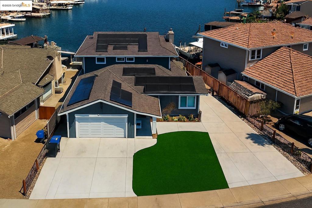 OMG - WE WANT THIS HOME - This fully remodeled home with updates all over the place and new roof in 2021 IS AMAZING and boasts five bedrooms and two and a half bathrooms, providing ample space for family living and entertaining. Situated on a prime waterfront location, this residence features a private dock, offering direct access to the delta, San Francisco Bay and the world. Tack on breathtaking long water views, and you're SET FOR GOOD LIFE. Upon entering, you are greeted by an open great room that seamlessly connects to an unbelievable kitchen. The kitchen is equipped with abundant cabinets, a dedicated coffee bar area, and high-quality finishes that will impress any culinary enthusiast. The dining and breakfast areas provide versatile spaces for both casual and formal dining experiences. The property includes two bedrooms on the lower level, ideal for guests or multi-generational living. The outdoor amenities are equally impressive, featuring a natural gas BBQ, a hot tub built into the deck with amazing views, and an outdoor refrigerator and bar area—perfect for hosting gatherings or enjoying tranquil evenings. For those with recreational vehicles, the side yard offers trailer, boat, or car storage, enhancing the property's functionality. OWNED SOLAR and so much more...