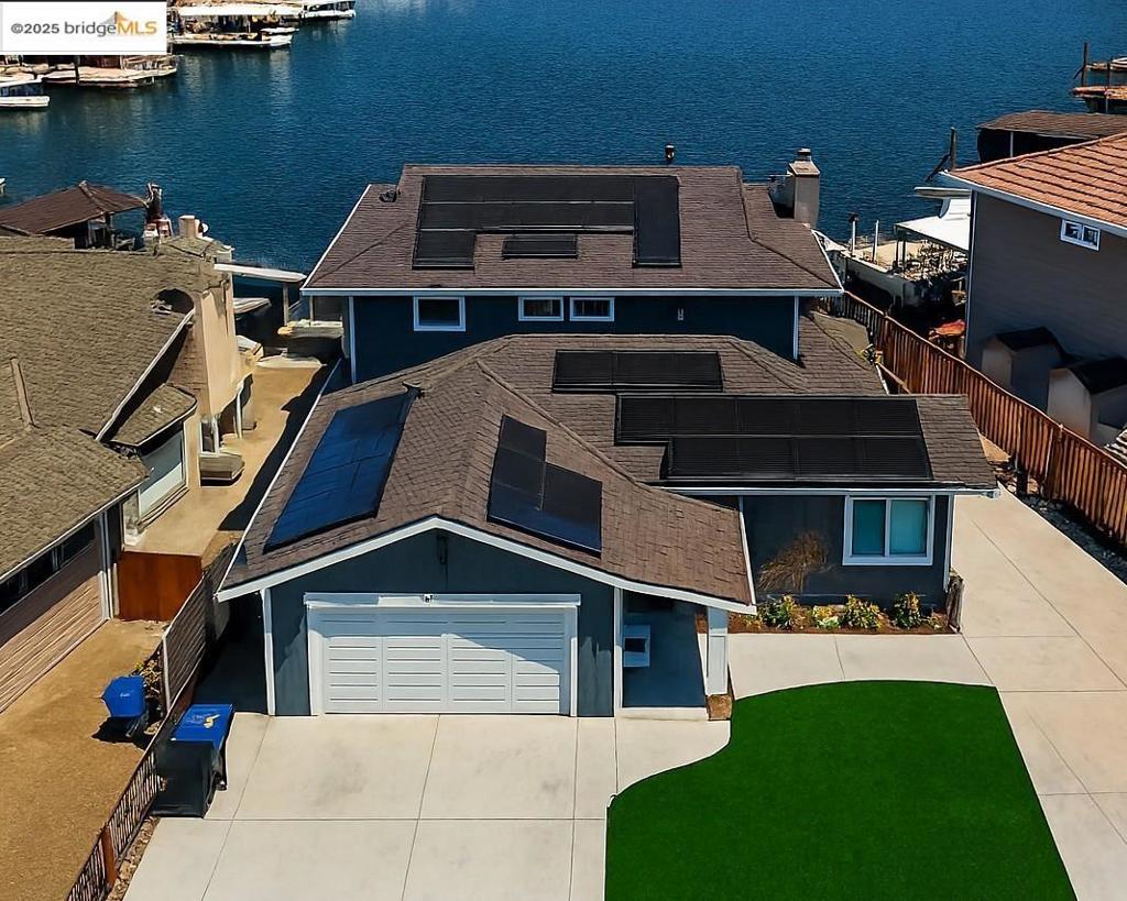 OMG - WE WANT THIS HOME - This fully remodeled home with updates all over the place and new roof in 2021 IS AMAZING and boasts 5 bedrooms and 2.5 bathrooms, with ample space for entertaining. Situated on a prime waterfront location with a private dock, offering direct access to the Delta, San Francisco Bay & beyond. The large decks feature breathtaking long water views. Upon entering, an open great room seamlessly connects to an unbelievable kitchen- equipped with abundant cabinets, a dedicated coffee bar, and high-quality finishes that will impress any culinary enthusiast. The dining & breakfast areas provide versatile spaces for both casual and formal dining experiences. The property includes two bedrooms on the main level, ideal for guests or multi-generational living. The outdoor amenities are equally impressive, featuring a natural gas BBQ, a hot tub built into the deck with amazing views, and an outdoor refrigerator and bar area—perfect for hosting gatherings or enjoying tranquil evenings. The side yard offers trailer/boat storage, enhancing the property's functionality. OWNED SOLAR and so much more... OPEN HOUSE SAT & SUN.