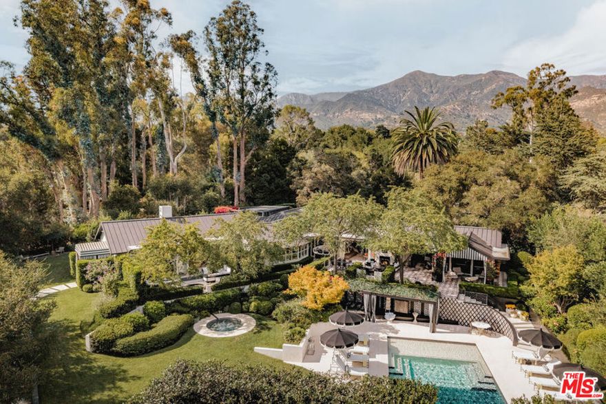 Unlike anything else on the market, this 2017-built Montecito estate blends high design with effortless glamour. Tucked down a private drive near the Upper Village, the gated retreat offers privacy and style across one lush acre. The 3BD/4.5BA single-level home boasts beamed ceilings, marble baths, steel windows, and seamless indoor/outdoor living. The primary wing features 3 garden patios, dual baths, and dressing rooms. A chic Parisian-inspired guest villa adds 885 sq. ft. with 3BD/1.5BA and 14-ft ceilings. Manicured grounds include a pool, cabana, spa, fire features, fountains, and sports court. A rare Montecito offering, where every day feels like an escape from the outside world.