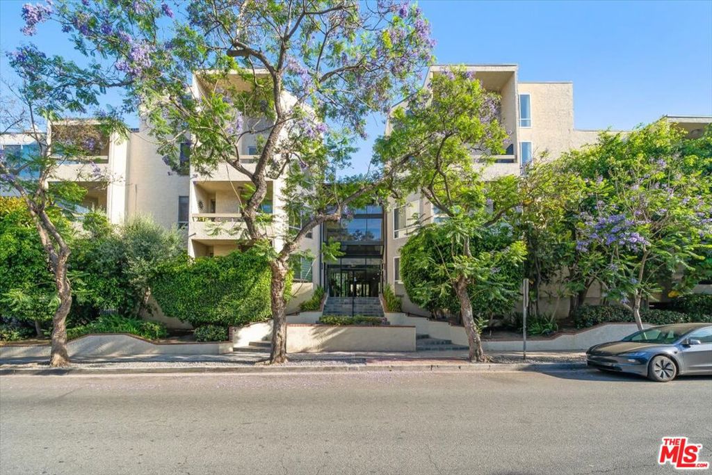 Discover luxury living in this stunning high-rise condo nestled in the coveted Norma Triangle of West Hollywood. This corner unit dazzles with floor-to-ceiling windows, flooding the space with natural light and showcasing breathtaking 180-degree panoramic views from downtown LA to Century City. The primary suite opens to a private balcony through elegant French doors, while the gourmet kitchen and spa-inspired bathroom feature custom tilework. Cozy up by the fireplace, enjoy the convenience of an in-unit washer/dryer, and unwind on the outdoor terrace, perfect for savoring vibrant sunsets and twinkling city lights. The living room seamlessly connects to this inviting terrace, ideal for entertaining or relaxing. Building amenities elevate your lifestyle with a sparkling pool, barbecue area, two side-by-side parking spaces, and ample storage. Steps from the iconic Sunset Plaza/Strip, Melrose Place, Pacific Design Center, and Soho House, and just minutes from Beverly Hills to the west and Hollywood Hills to the north and east, this condo offers unparalleled access to the best of LA's dining, shopping, and entertainment. Embrace the ultimate urban oasis!