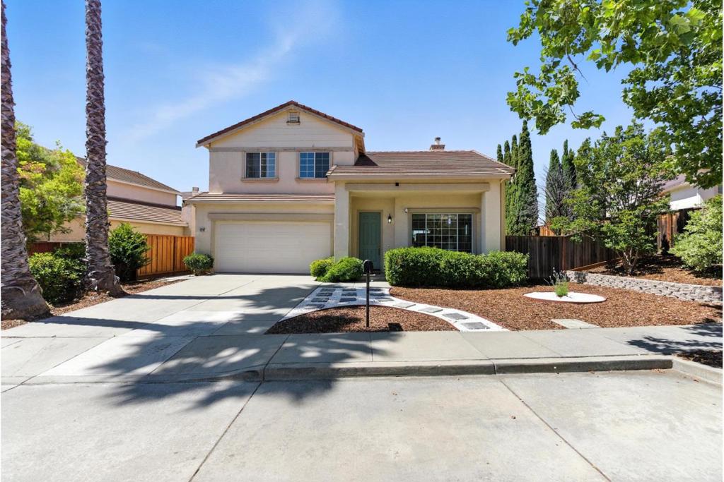 Vaulted Ceilings, Half High Wall, Numerous Windows - Spacious Ambiance If you are hoping to find a home with a spacious open ambiance, this home should be at the top of your to-see list. Both the living room and the family room on the ground floor have two story high vaulted ceilings. Large windows at typical heights are complemented by windows placed high on the walls. A half-high wall separates the living room from the family room building on the spacious ambiance. The modern kitchen features white appliances, granite counter tops, a tile floor, an island, overhead recessed lighting, and under cabinet lighting. It is open to the breakfast area and family room. Numerous views of the backyard create a delightful meal preparation area. Bedrooms have carpeted floors. The primary bedroom has a vaulted ceiling, a large en-suite bathroom, and walk-in closet. One bedroom is on the ground floor with an adjacent bathroom.