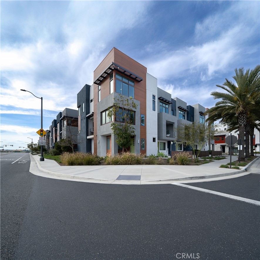 STUNNING MODEL HOME WITH PANORAMIC PARK & MOUNTAIN VIEWS — This beautifully upgraded CORNER UNIT is flooded with NATURAL LIGHT and showcases some of the BEST VIEWS in Tustin Legacy. Over 2,200 SQFT of open living space, only ONE SHARED WALL, and thoughtfully designed finishes make this home truly one of a kind. Enjoy a versatile 4 BED / 3.5 BATH layout, including a private FIRST-FLOOR BEDROOM with a FULL EN-SUITE BATH—perfect for guests or a home office. The MAIN LEVEL offers an expansive great room and a sleek CHEF’S KITCHEN featuring quartz countertops, smart stainless-steel appliances, a generous island, and a covered balcony that frames the PARK & HANGAR VIEWS beautifully. Upstairs, the PRIMARY SUITE is a SHOWSTOPPER, with oversized windows that capture morning light and sweeping views of the park and surrounding landscape. Two additional bedrooms complete the top floor, each offering its own scenic outlook. Located in the desirable Levity Community, this home includes access to RESORT-STYLE AMENITIES—pool, spa, and BBQ area—and is just steps from Victory Park, top-rated schools, and The District at Tustin.