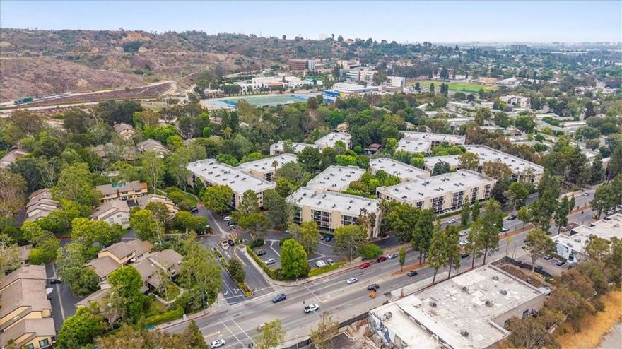 Welcome to this beautifully updated top-floor 1 bed, 1 bath condo in the desirable Raintree community of Culver City. This light and airy 740 sq ft unit features stylish wood-style laminate flooring throughout, a cozy fireplace, and an open-concept living/dining area with treetop views. The spacious balcony offers a peaceful retreat, perfect for morning coffee or evening relaxation. The kitchen includes ample cabinet space and a convenient adjacent wet bar for entertaining. The generously sized bedroom features dual closets and easy access to the full bath. Located in a guard-gated complex, Raintree offers resort-style amenities including a large, heated pool, spa, fully equipped fitness center, volleyball court, clubhouse, library, and scenic walking trails across 6+ acres of park-like grounds. This unit includes two tandem parking spaces in a secured garage, plus elevator access directly to the top floor. Centrally located near downtown Culver City, studios, Baldwin Hills Scenic Overlook, and top-rated schools. HOA dues cover internet, water, gas, trash, security, and exterior maintenance. Don't miss this rare opportunity to own in one of Culver City's most sought-after communities!