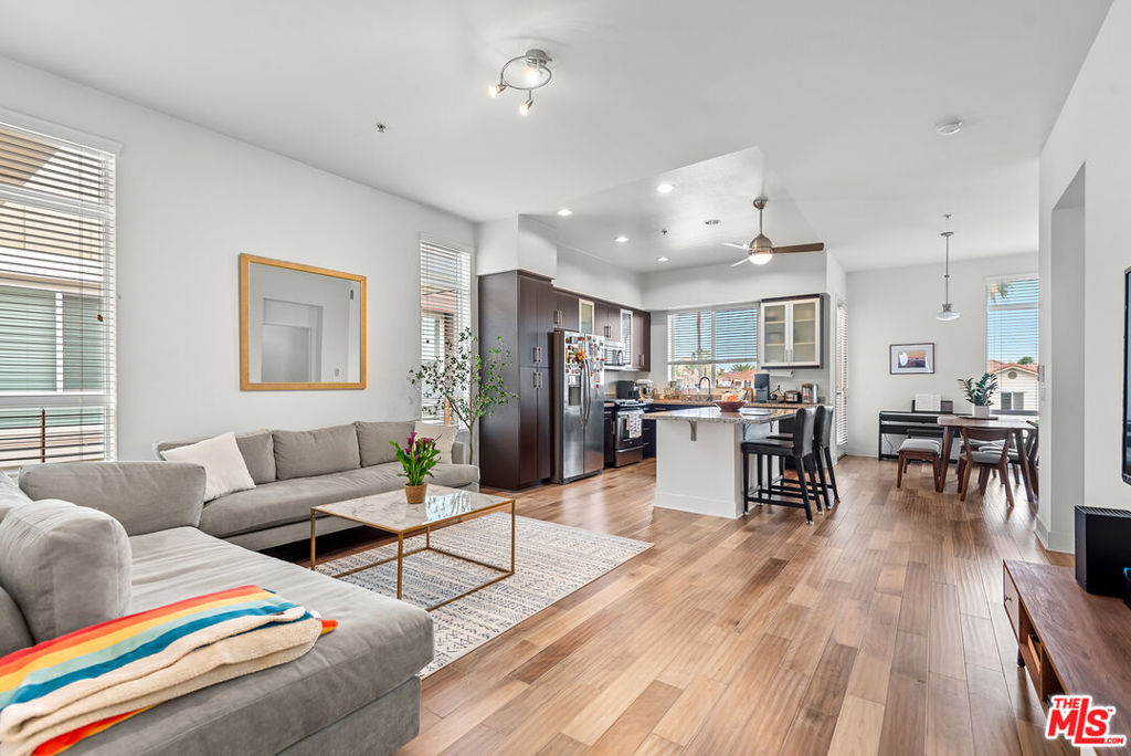 Step inside this stunning top-floor contemporary retreat located in Playa Vista's highly sought-after Primera Terra community. This beautifully maintained single-level condo offers 1,310 sq. ft. of stylish, open-concept living. This light-filled space features a seamless open kitchen-to-living room layout, perfect for entertaining, with direct access to a beautiful north-facing balcony ideal for relaxing or enjoying your morning coffee. The thoughtfully designed floor plan places the primary suite on one side, complete with a walk-in closet and elegant ensuite bathroom, while two additional bedrooms are near the front of the unit and ideal for guests, family, or a home office setup. A dedicated laundry and extra storage closet add to the convenience. Two assigned side-by-side parking spaces in the garage. Nestled perfectly between Playa Vista's Phase 1 and Phase 2, you're just a short stroll from parks, library, Playa Vista Elementary, Centerpointe Club, The Resort, Whole Foods and everything else this vibrant community has to offer.