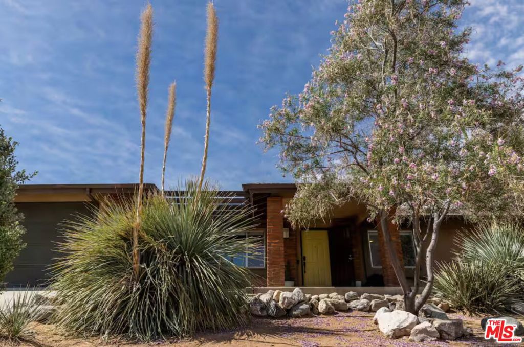 Located in a peaceful cul-de-sac on the desirable south side of Yucca Valley, this spacious home blends comfort, charm, and modern upgrades for the perfect desert retreat. Step inside to an open floor plan featuring a sophisticated family room with a cozy fireplace and built-in book cases ideal for gatherings. A formal living area provides additional space to relax and entertain, while the sunroom offers a versatile space, perfect for a home office, playroom, or lounge. The beautifully remodeled kitchen is a chef's dream, with ample storage, stainless steel appliances, and a center island for extra prep and seating space. The primary suite is a true sanctuary with direct patio access, a spacious walk-in closet, and an en-suite bathroom for added privacy and convenience. The second bedroom is large enough for a king-size bed and the third bedroom features a custom built-in desk. A well-appointed hall bath is conveniently located across from the two guest rooms. Designed for year-round comfort, the home is equipped with double-pane windows and a brand new HVAC for central heating/air conditioning. Outside, the fully fenced backyard is a private oasis featuring mature landscaping, raised garden beds, a hot tub, cowboy pool, and a covered pergola perfect for outdoor dining, grilling, and soaking in the serene desert atmosphere. The attached double car garage provides direct access for added convenience. This home is available fully furnished, making it a seamless move-in-ready opportunity or an Airbnb-ready investment from day one!