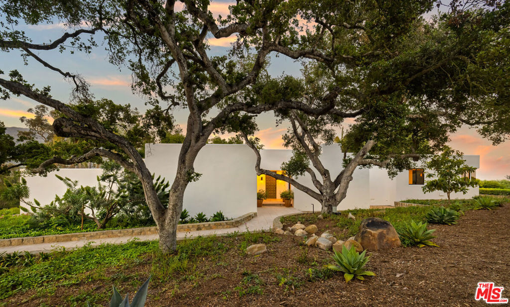 Dramatic moments unfold throughout this gated Pepper Hill estate, where bold architectural lines & natural textures are artfully woven together across 1.5-acres of striking mountain & ocean views. The 3bd/4.5 ba home flows to a natural rhythm w sunlit, single-level living celebrating both scale & intimacy thru-out the spacious kitchen & family room, poolside formal dining room & private bedroom suites. Floor-to-ceiling glass dissolves the boundary between indoors & sun-drenched patios, a luminous pool, serene grounds & a 1bd/1ba artist studio welcome resort-style living. *Detached artist studio has an additional room and un-permitted bath*