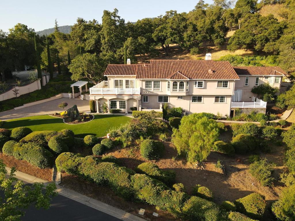Nestled in the prestigious community of Los Altos Hills, this exquisite 4,428 sq ft 5bd, 3.5 bath residence combines luxury and livability. The chefs kitchen boasts high-end appliances, custom cabinetry, a large island with seating, and work station. Ideal for remote work or study, the dedicated office space features built-in shelving, desks and inspiring views. The master suite includes a walk-in closet and an en-suite bath with dual vanities, a soaking tub, and a separate shower. Large fifth bedroom can also be utilized as a gym or playroom offering a large accompanying patio. Step outside to discover your private backyard paradise. The pool and hot tub invite limitless relaxation, while the expansive patio is perfect for entertaining or simply enjoying the panoramic views of the surrounding hills. Situated on a peaceful lot, surrounded by lush landscaping, this home offers a tranquil retreat while still being located within a convenient commute corridor and close to all the shopping and dining options in the quaint community of Los Altos. Includes a three-car garage, ample built-in storage, and additional gated parking. Top-rated schools. This exceptional home in Los Altos Hills is a rare find, combining luxurious living with stunning natural beauty.