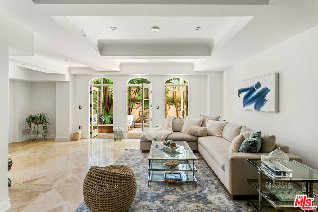 Welcome to The Venezia, a prestigious full-service building on the Wilshire Corridor. Elegant coffered ceilings and pristine stone floors welcome guests through the formal entry into the open concept floor plan. The expansive living room harmoniously flows through grand arched doorways to the private outdoor patio framed by lush greenery, offering a serene setting to dine al fresco and welcoming in an abundance of natural sunlight. The chef's kitchen is fully equipped with new Thermador appliances and generous Caesarstone quartz countertops with a breakfast bar, in addition to the adjacent dining area. The primary suite, adorned with rich hardwood floors, offers dual closets and a luxurious en suite with spa tub. A secondary bedroom, with its' own en suite, a powder room, and laundry area complete this highly functional layout. A seldom available opportunity to reside in The Venezia and enjoy 24-hour concierge service, a state-of-the-art fitness center, and a swanky rooftop with an outdoor kitchen and sweeping panoramic views. Walking distance to Westwood Village and UCLA. Just minutes from renowned Beverly Hills dining and entertainment.