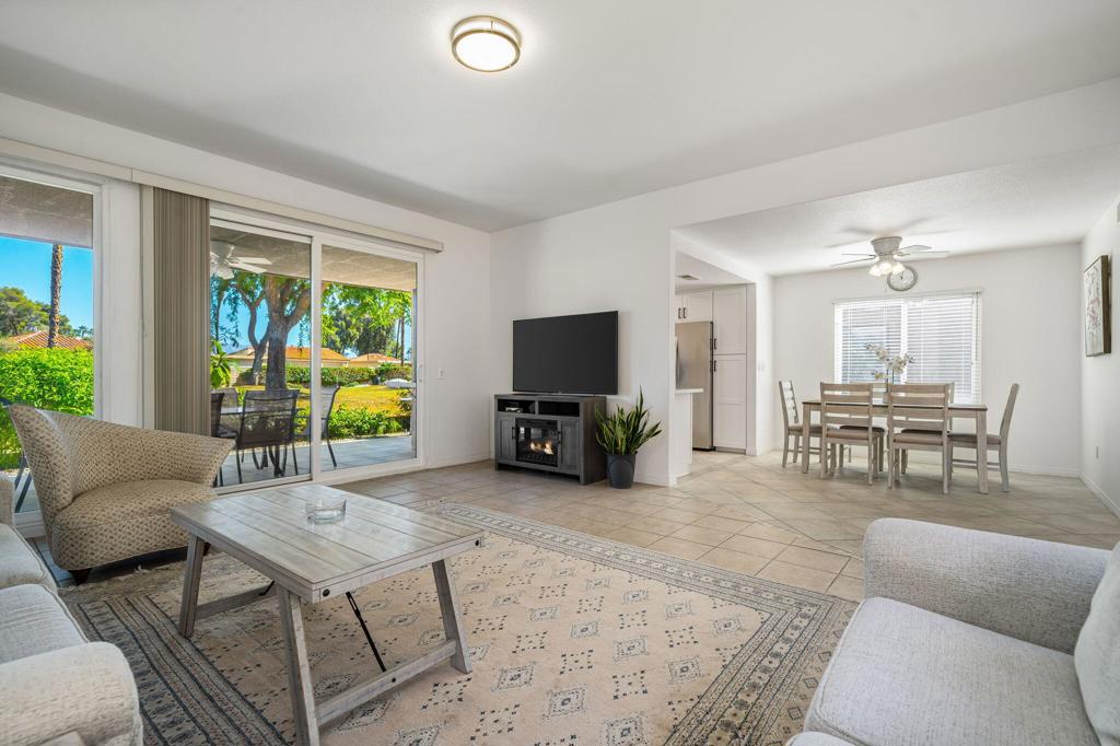 Bring your toothbrush, this home has it all!  Seller just put over $120K of improvements into this gorgeous condo located in the highly sought-after Sunrise Country Club.   This light, bright, fully furnished and meticulously cared for 3 bedroom, 2 bath home has just been completely updated in every single living space.   New paint, flooring, windows, appliances, washer/dryer, water heater, sinks, toilets, fans, lighting, switches, BBQ;  even all the furniture and art are new! The tasteful $5,000 hand loomed Persian rug is included!  A newer HVAC unit is also a plus when temperatures rise. As you enter this inviting retreat, neutral desert tones greet you. The updated Atrium is the centerpiece of the home; another plus that provides more light and brings soothing nature inside.  This very popular Barcelona floor plan with 1,581 square feet of living space is located on a very quiet greenbelt with views of the mountains and lush greenery and fruit trees just outside your kitchen and living room windows.**Cozy Evenings:** The living area is complemented by an electric fireplace, ensuring warm and cozy experiences. **Modern Upgrades:**  Enjoy stylish ceramic tile flooring in soothing desert hues, with both bathrooms fully updated including quartz counters and zero-threshold walk-in showers with grab bars, making both bathrooms handicapped friendly..This residence has been very thoughtfully  updated, designed to embrace comfort and style. **Chef's Delight Kitchen:**   The well-adorned kitchen is a cook's dream, featuring elegant light quartz countertops, electric cooktop, stainless steel appliances, and a scenic corner of windows that let in natural light and desert views.   Experience stylish ceramic tile flooring throughout, with the third bedroom currently set up as a media room, perfect for enjoying your favorite entertainment. **Ample Storage:**  Lots of cabinets and closets throughout this home will keep things accessible with ease. The quiet back patio area has been beautifully renovated as well, with new tile flooring, patio furniture and shiny BBQ to enjoy dreamy desert evenings or to entertain family and friends.  Sunrise Country Club is celebrated as ''The friendliest club in the desert,''  offering an array of amenities, including a state of the art fitness center, an 18-hole golf course, 14 tennis and pickleball courts and a very friendly community. Flexible membership options are available too! Hurry, this won't last!