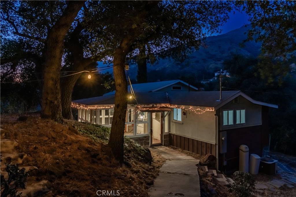This AMAZING property is nestled at the TOP OF THE HILL on an over 5 ACRES LOT surrounded by trees and 360 Degrees CITY LIGHTS VIEWS!!! A true opportunity for developers and investors with potential for subdivision or homeowners to build a spectacular dream home. The main house has living room with stone fireplace and 2 large enclosed patios. This property features one bedroom and one bathroom. There is also a large basement with storage and laundry area. Upgrades included dual pane windows and fully paid solar system. Detached guest house with kitchen, family room, full bath and large loft used for bedroom, perfect for as a rental unit or for extended family living. Huge flat lot has many RV parkings, room for pool/spa, chickens or horses with plenty of room for a training ring. This is ONE OF THE KIND property offering endless possibilities. It is a dream home for someone looking to get away from it and enjoy living in their own private.