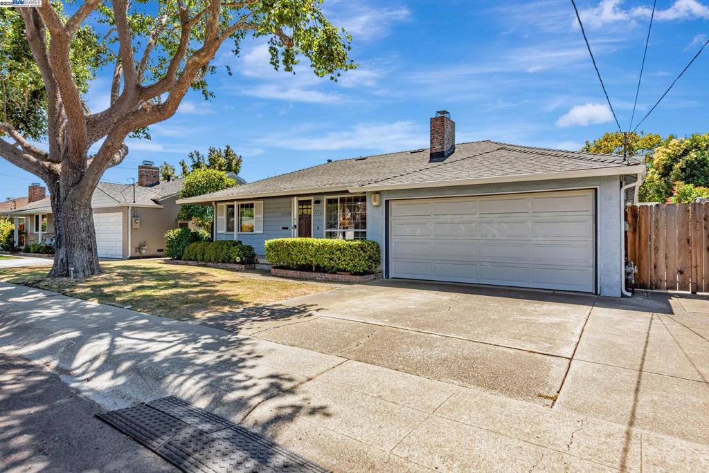 Tucked away in the charming and historic San Lorenzo Village, this beautifully updated single-level home offers 4 bedrooms, 2.5 bathrooms, and nearly 1,800 sq ft of living space on a quiet, tree-lined cul-de-sac. Ideally situated near schools, major highways, BART, shopping, and entertainment, it offers both convenience and tranquility. The modern open-concept layout features refinished hardwood floors throughout and centers around a sunlit courtyard accessible from both the primary suite and the bonus room—perfect for entertaining or family gatherings. The private primary retreat boasts a walk-in closet and an upgraded en-suite bathroom. Enjoy cozy evenings by the wood-burning gas fireplace in the vaulted-ceiling living room, complemented by contemporary lighting and fresh interior paint. The stylish kitchen is equipped with brand-new stainless steel appliances and fixtures, making meal prep a pleasure. A spacious 2-car garage with an EV charger offers ample storage and direct access to the home and side yard. With a brand-new roof (installed less than 3 months ago), this turnkey home is truly move-in ready—ideal for families seeking comfort, style, and peace of mind.