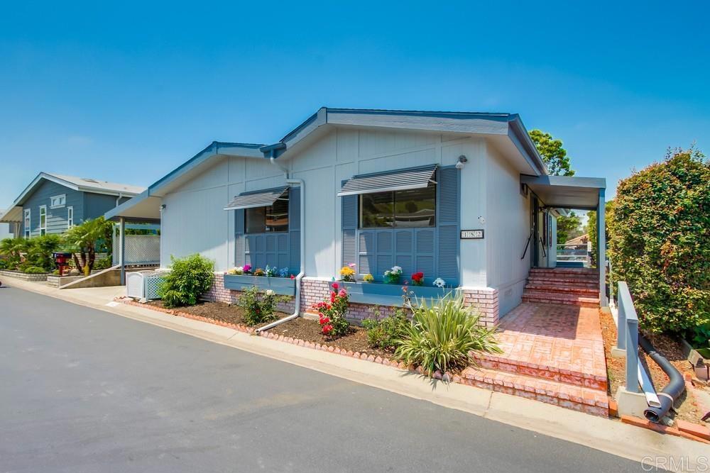 Back on the market at no fault to the seller. Enjoy the wonderful ocean breeze on your back deck and throughout this home located in highly desired Palomar Estates West. This home features a large living room with a cozy fireplace. The updated kitchen features white cabinets with quartz counter tops. The oversized primary bedroom has a walk-in closet and an on-suite bathroom. The home has been drywalled throughout the home. The large laundry room gives you extra storage space. Palomar Estates West is a 5 star 55+/35+ senior rent controlled park with many activities and amenities including a beautiful clubhouse, pool, spa, gym, putting green, pickleball courts, and tennis courts. This home is located minutes to Lake San Marcos dining and golf as well as local Carlsbad beaches, shopping, and restaurants.