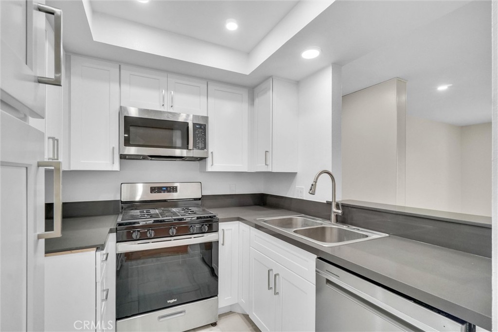 Absolutely gorgeous, NEWLY REMOLDED, AND UPGRADED in the heart of Downtown Santa Ana WITH NO ONE LIVING ABOVE YOU! THIS BEAUTIFUL CONOD is in the gated Town Square community. Step inside to a bright, open concept living space featuring wood floors, new kitchen, brand new vanities throughout, All brand new double pane windows,New AC, NEW TILE FLOORS in kitchen and bathrooms. Kitchen boasts NEW countertop, NEW KITCHEN CABINETS. From Living room step into THE BALCONY offering storage closet. Two LARGE bedrooms along with 2 remodeled bathrooms. Enjoy resort-style community amenities, including two pools, two spas and secure underground parking with TWO ASSIGNED CAR SPACES. The HOA covers water and trash for low-maintenance living. Located in the vibrant Flower Park neighborhood, you’re steps from the Santa Ana Civic Center, Artist Village, and 4th Street’s trendy eateries and nightlife. With easy access to the 5 and 55 freeways and the Santa Ana Regional Transportation Center, commuting is a breeze. Perfect for first-time buyers, investors, or those seeking a low-maintenance urban lifestyle, this condo is a rare find in a thriving downtown hub.